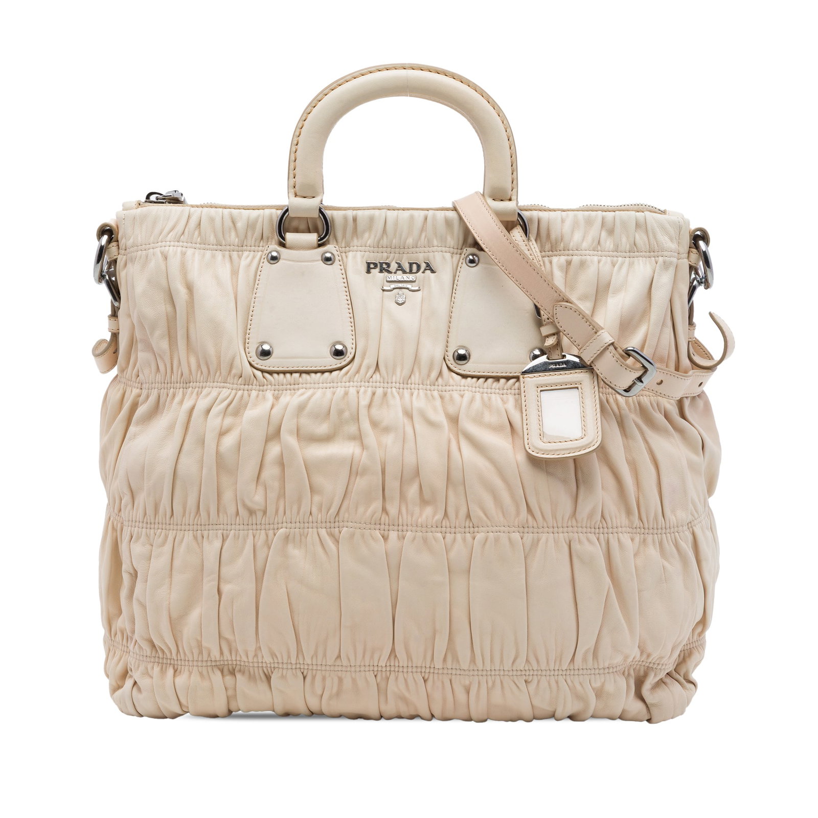 Prada Nappa Gaufre Leather Satchel Bag Beige: Prada Nappa Gaufre Leather Satchel Bag Beige Prada Nappa Gaufre Satchel in beige leather with a gathered design, dual flat leather handles, and an adjustable, detachable flat leather strap. The bag fe