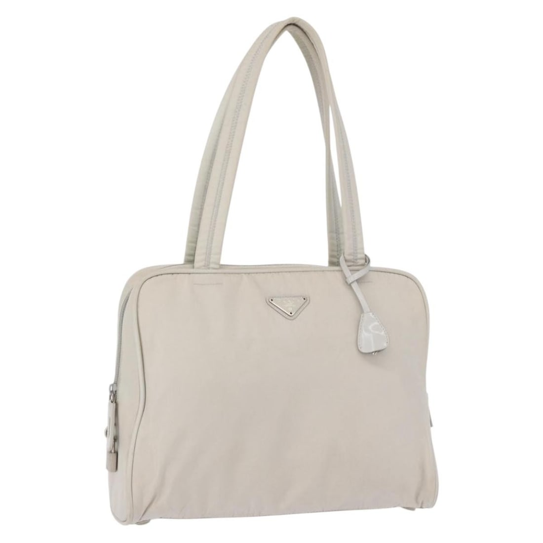 White and Silver Nylon PRADA Tote Bag with Padlock and Keys: White and Silver Nylon PRADA Tote Bag with Padlock and Keys This PRADA tote bag features a white and silver nylon exterior and is crafted in Italy. The bag includes a padlock, two keys, a clochette, a