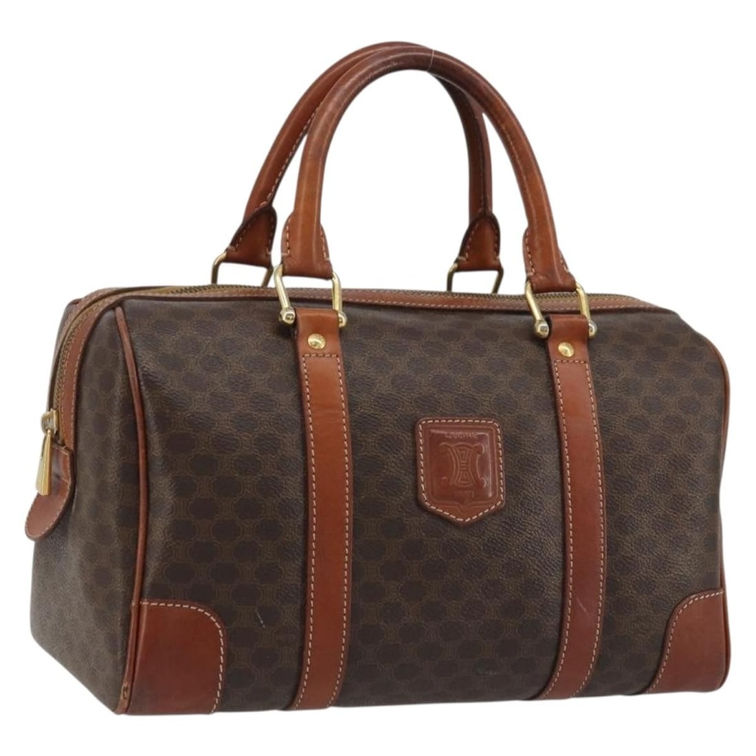 Celine Macadam Brown PVC Leather Handbag with Gold Accents: Celine Macadam Brown PVC Leather Handbag with Gold Accents This CELINE Macadam Canvas hand bag is crafted from durable PVC leather and features the iconic brown and gold color scheme. Designed for wom