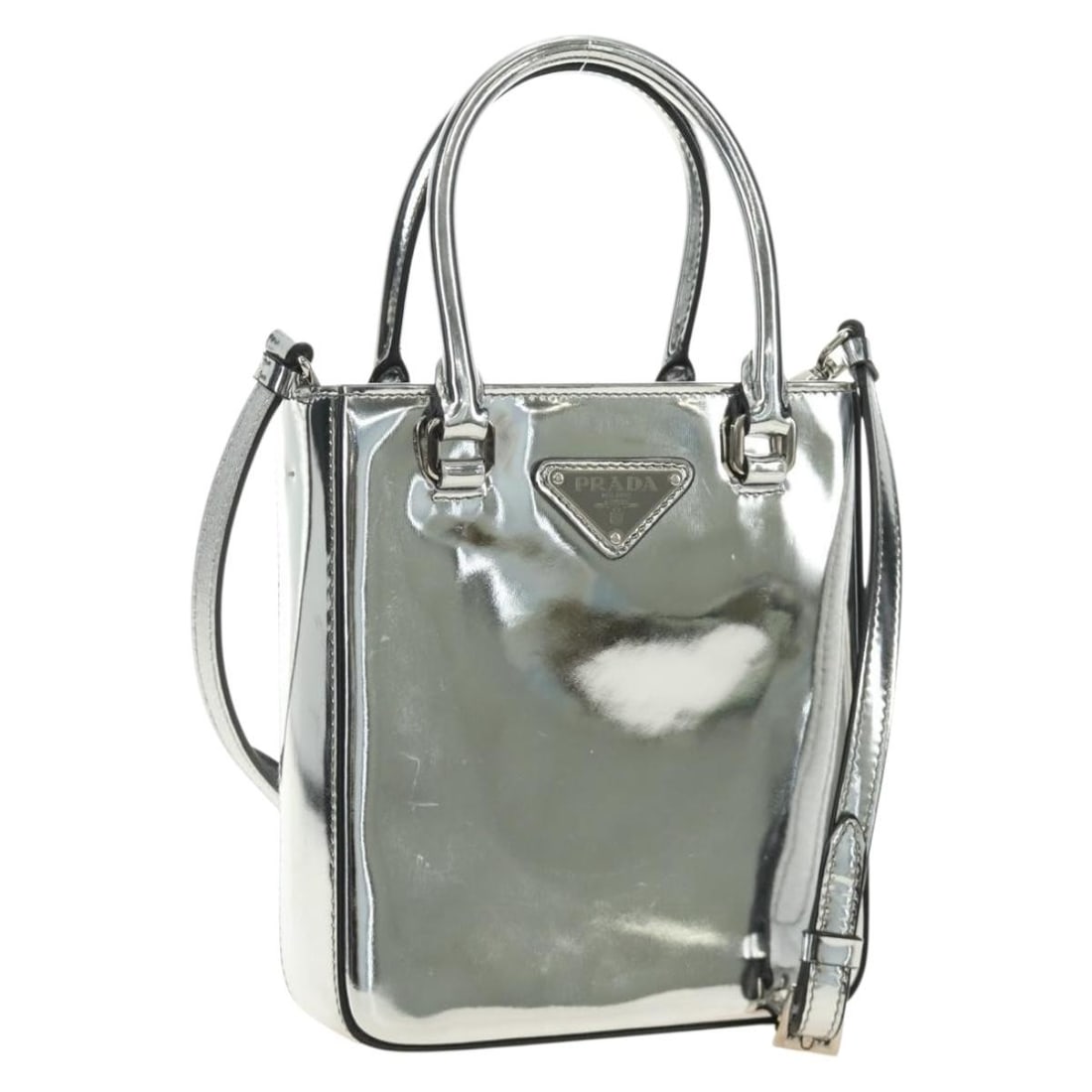 PRADA Silver Patent Leather 2way Hand Bag with Shoulder Strap: PRADA Silver Patent Leather 2way Hand Bag with Shoulder Strap Prada 2-way patent leather handbag in silver with a structured compact silhouette. Includes a dust bag and shoulder strap. Made in Italy. 