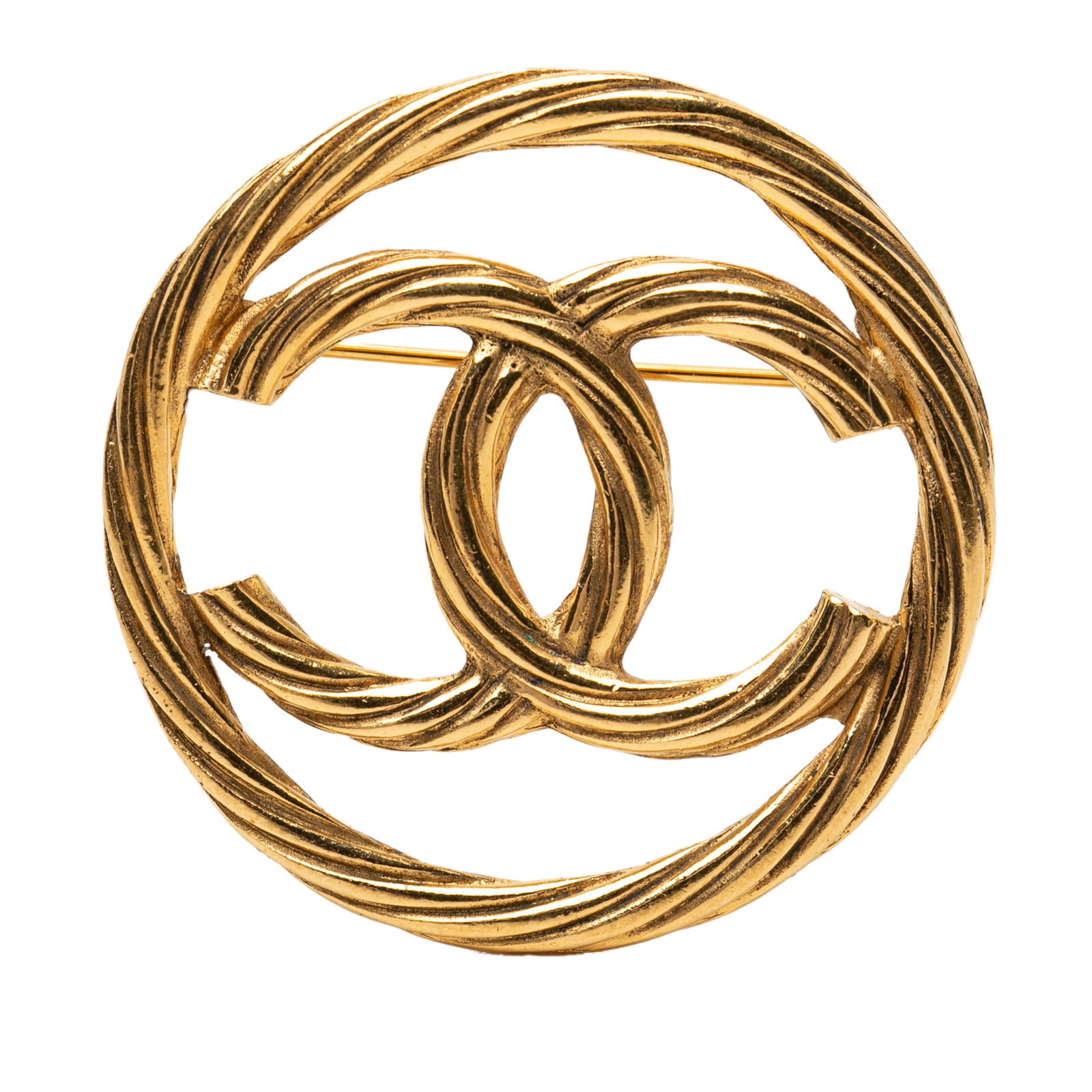 Chanel CC round gold tone metal brooch: Chanel CC round gold tone metal brooch Round Chanel CC brooch in gold-tone metal with a back pin closure. This costume jewelry piece is made in France and shows wear including discoloration and scratc