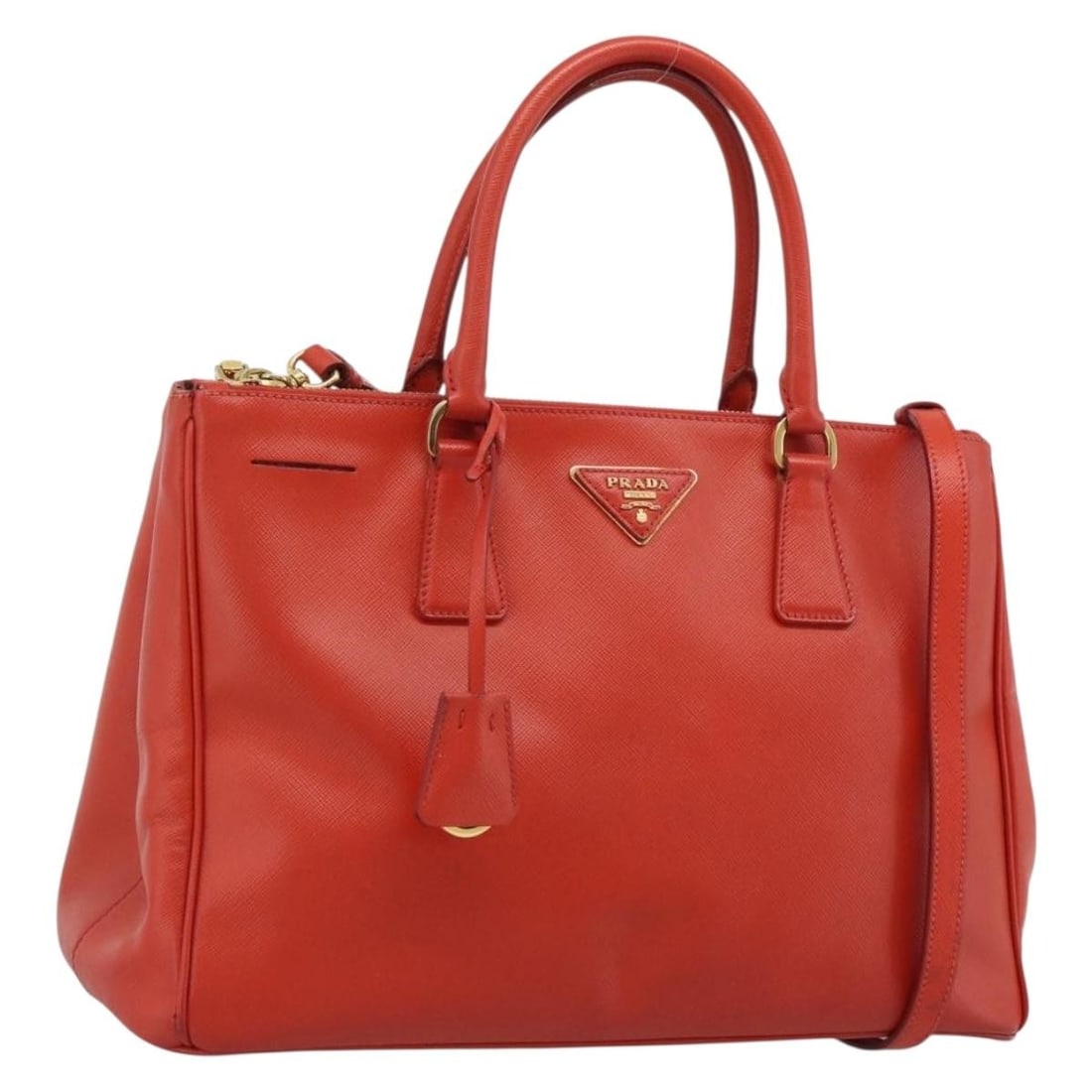 Prada Saffiano Leather 2 Way Handbag Orange with Shoulder Strap: Prada Saffiano Leather 2 Way Handbag Orange with Shoulder Strap Prada women's 2-way handbag in orange Saffiano leather with gold-tone accents. Made in Italy, this handbag includes a clochette and shou