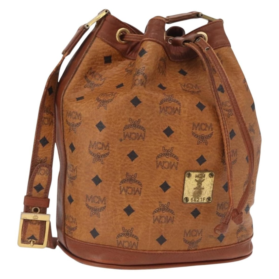 Brown PVC Leather MCM Vicetos Shoulder Bag with Gold Details: Brown PVC Leather MCM Vicetos Shoulder Bag with Gold Details This MCM Logogram Vicetos shoulder bag features a brown and gold PVC leather exterior, offering a stylish and recognizable design. The bag 