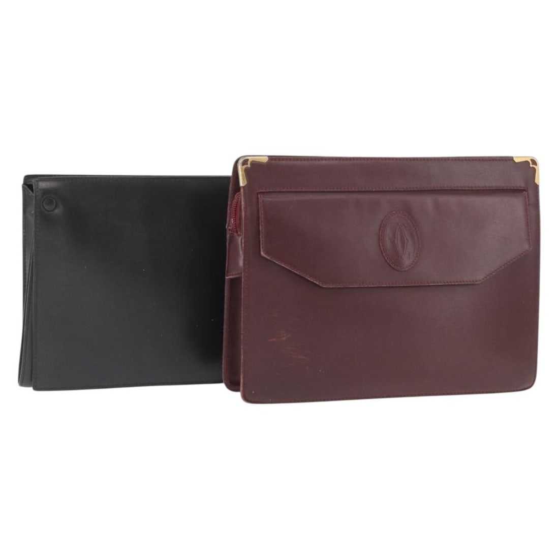 Leather clutch duo in black and bordeaux by Cartier: Leather clutch duo in black and bordeaux by Cartier This is a set of two Cartier clutch bags crafted from leather in black and bordeaux. Made in France, these clutches feature signs of heavy use, incl