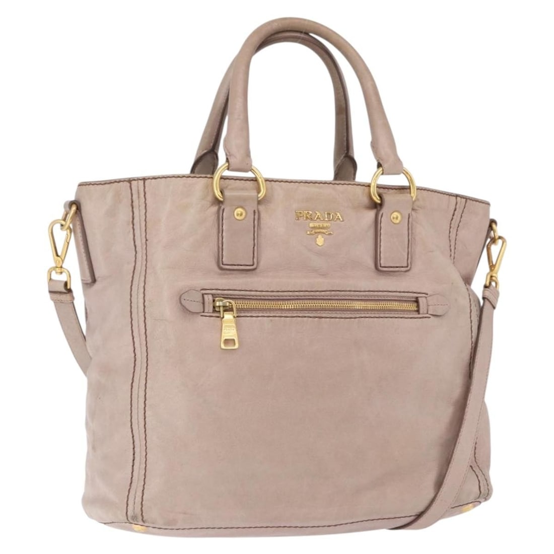 PRADA Beige Leather 2 Way Handbag with Shoulder Strap: PRADA Beige Leather 2 Way Handbag with Shoulder Strap Prada beige leather 2-way handbag with gold-tone accents and a detachable shoulder strap. Made in Italy, this women's bag can be carried by the ha