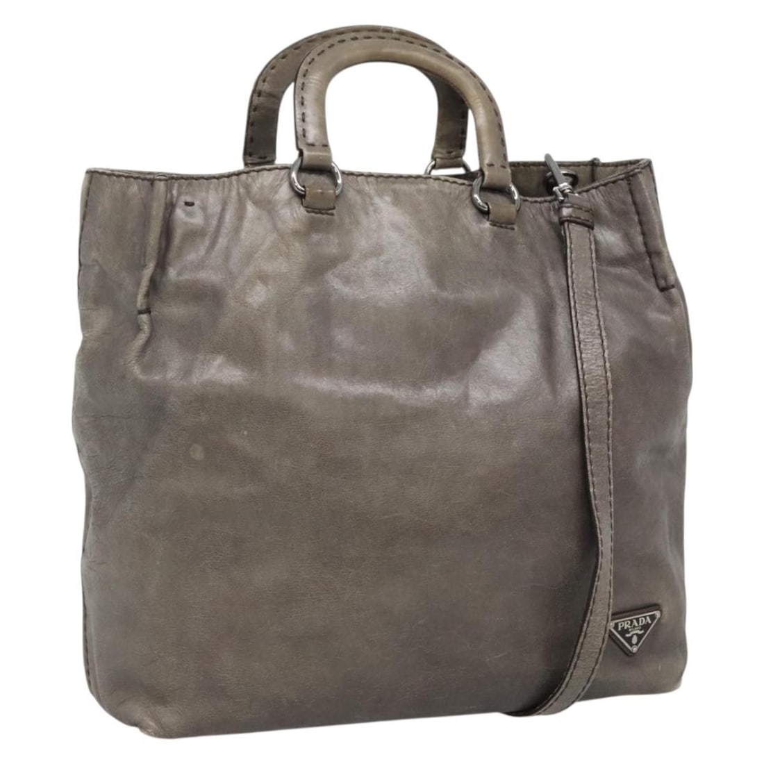 Prada gray silver leather handbag with shoulder strap: Prada gray silver leather handbag with shoulder strap This PRADA 2-way handbag features a versatile design crafted from gray and silver leather. Made in Turkey, it can be carried by hand or worn over 