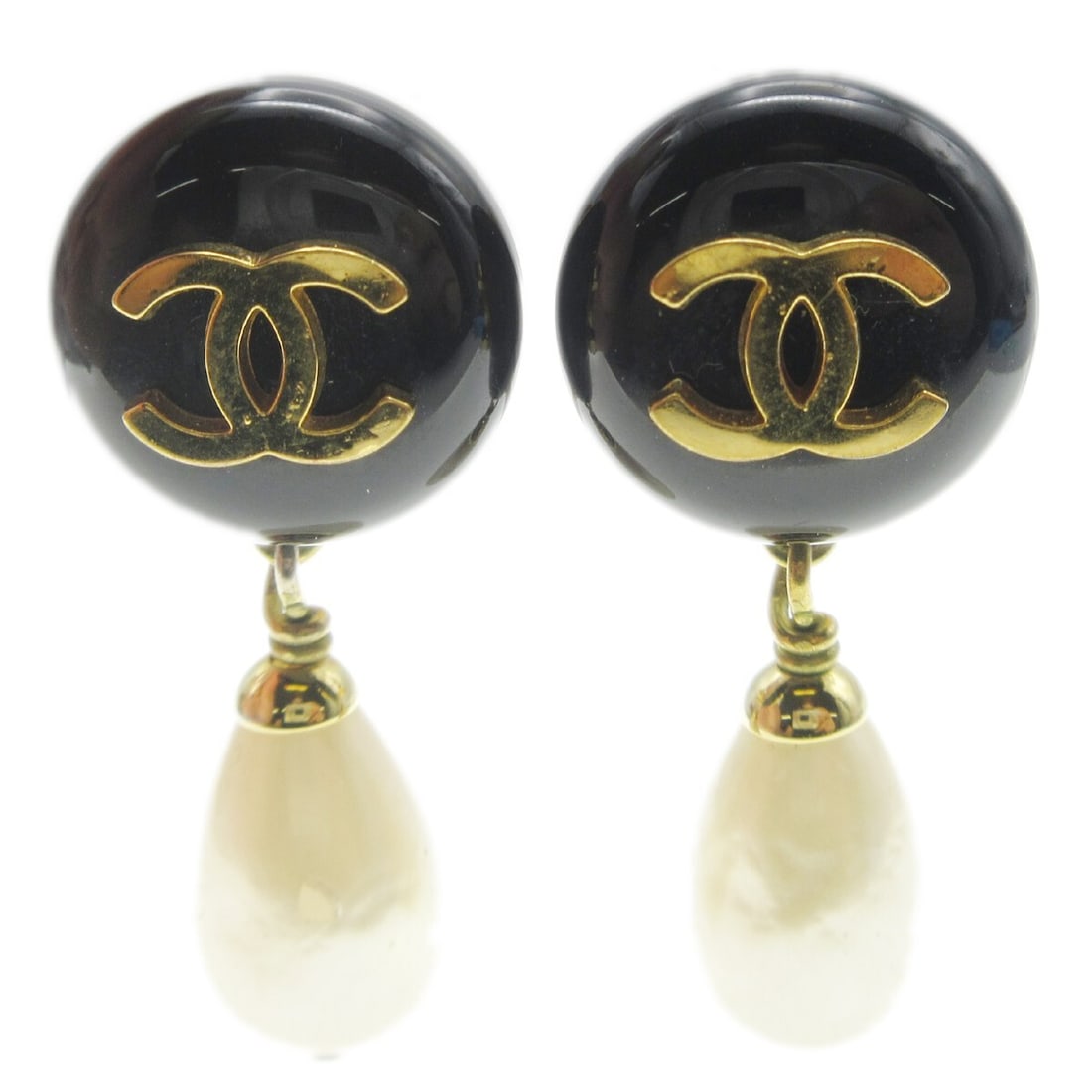 Chanel 94A clip on dangle earrings with artificial pearl: Chanel 94A clip on dangle earrings with artificial pearl Clip-on Chanel dangle earrings featuring black, white, and gold-tone detailing with artificial pearl accents. Made in France, this pair has a d