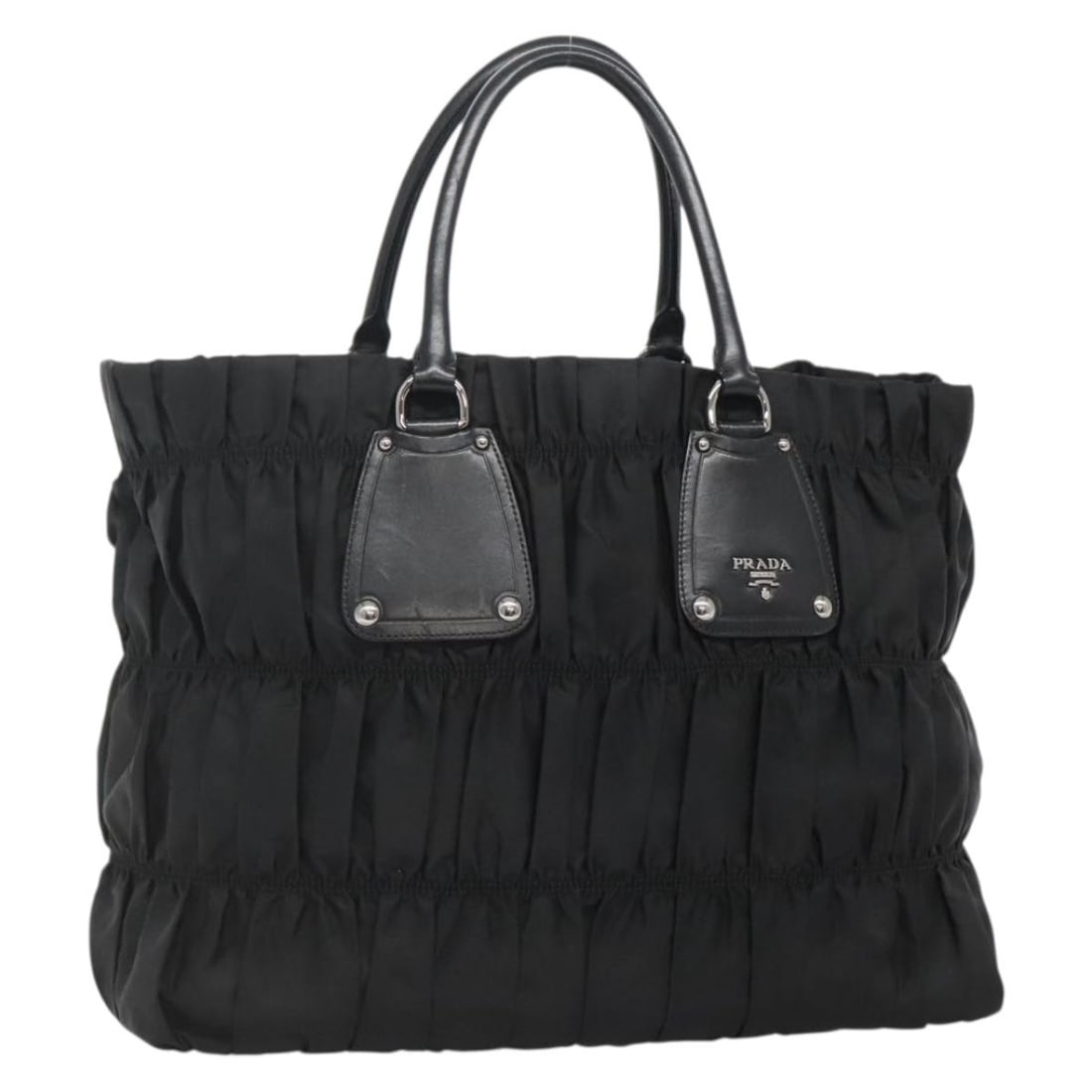 Black Nylon Gaufre Tote Bag by Prada 37cm by 30cm by 14cm: Black Nylon Gaufre Tote Bag by Prada 37cm by 30cm by 14cm This Prada Gaufre Tote for women is crafted from black nylon, featuring a spacious design ideal for everyday use. It shows slight signs of wea