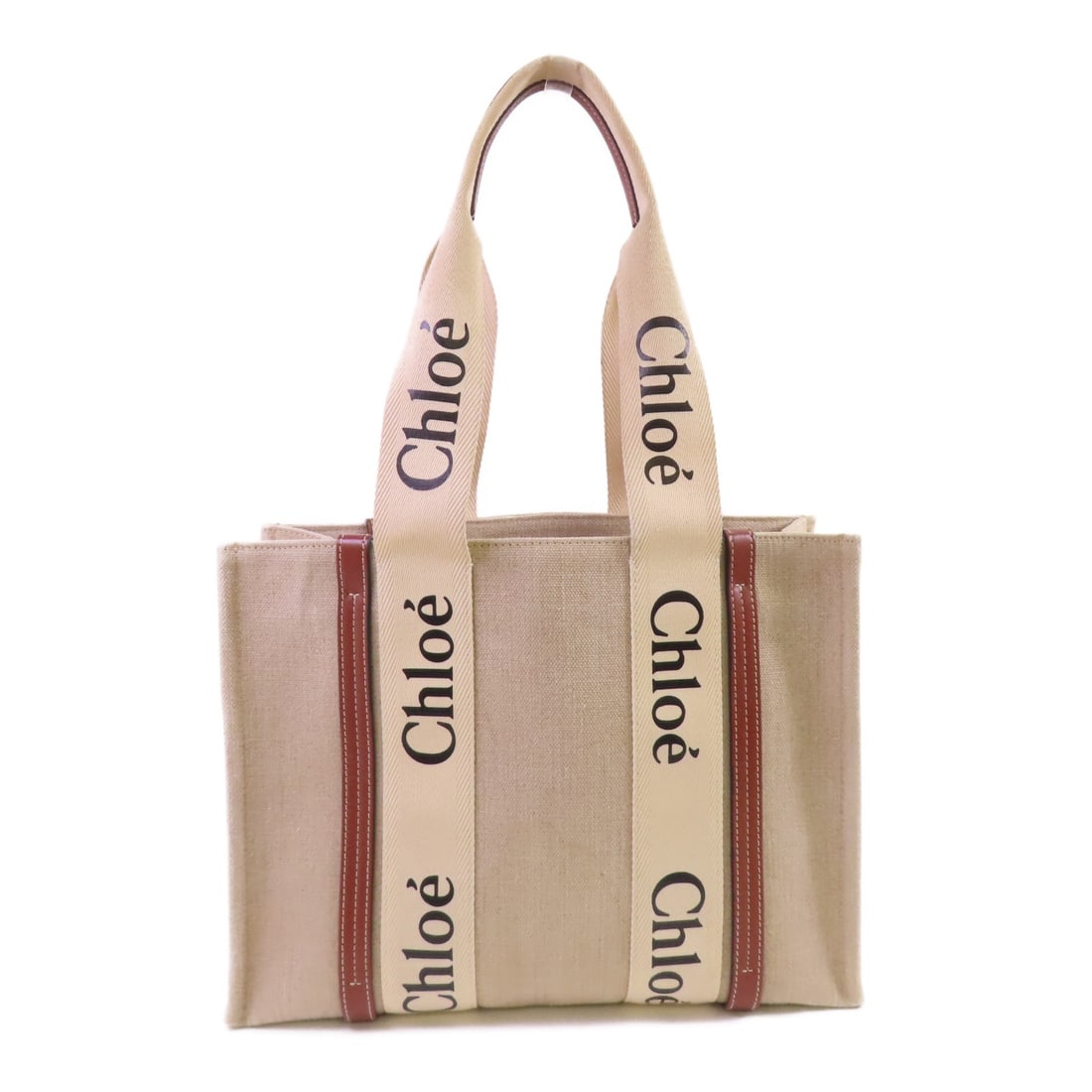 Chloe Woody Canvas Tote Shoulder Bag in Beige: Chloe Woody Canvas Tote Shoulder Bag in Beige Chloe Woody tote bag in beige canvas with a shoulder-carry design and a clean, versatile look. The interior includes one open pocket. Condition is rated A