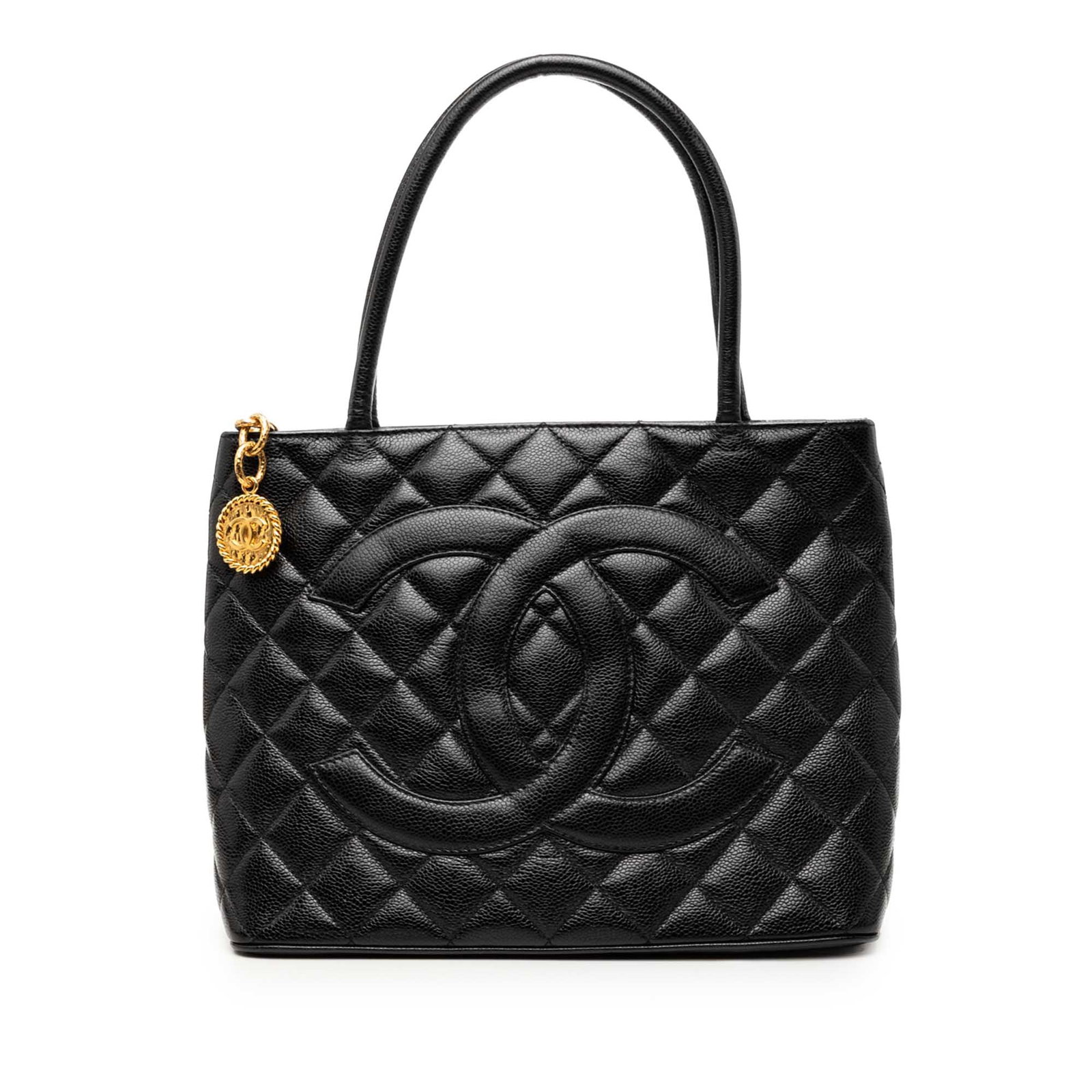 Chanel Medallion Tote in Black Caviar Leather: Chanel Medallion Tote in Black Caviar Leather Chanel Medallion tote crafted in quilted caviar leather with rolled leather handles and a top zip closure. The bag includes an exterior back slip pocket a