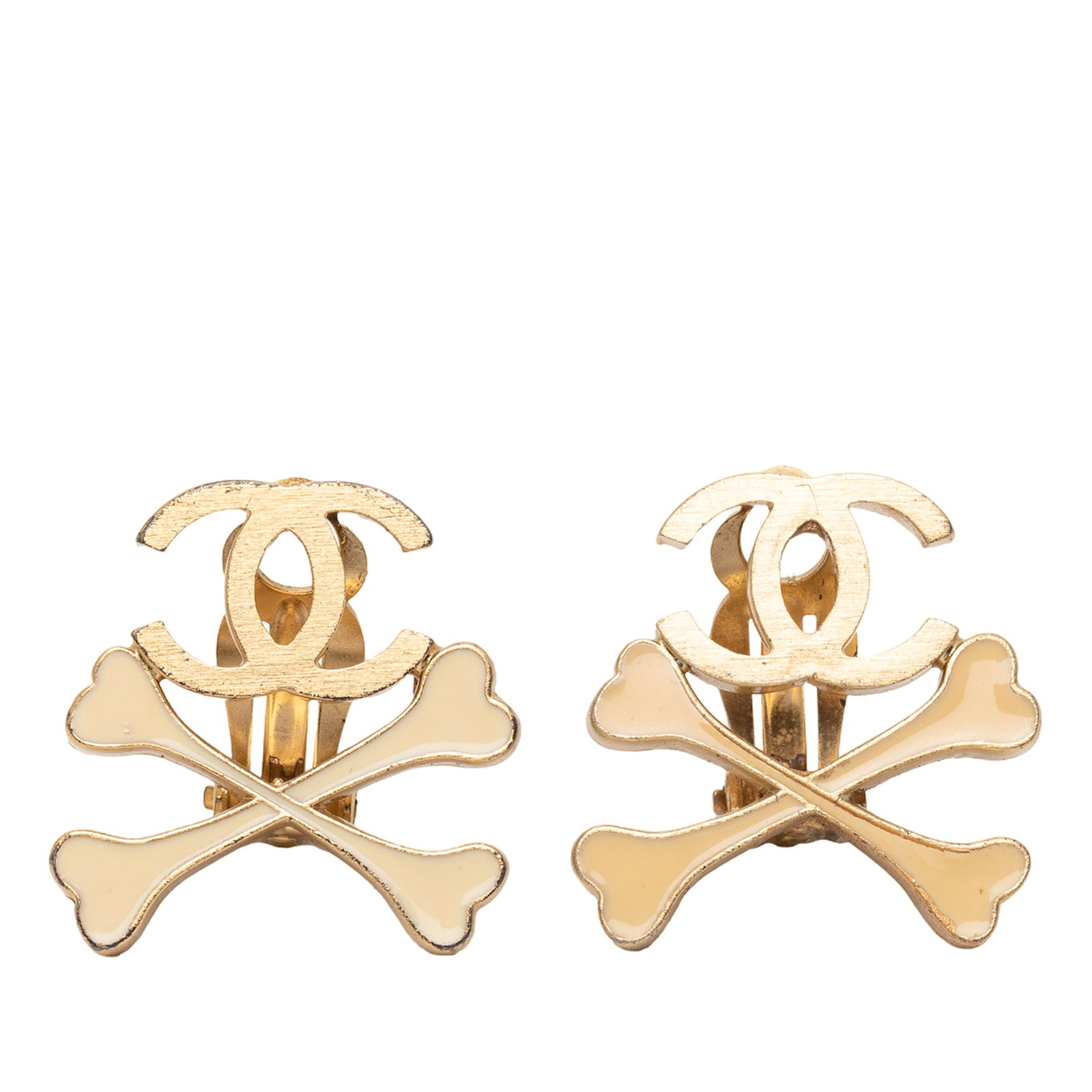 Chanel CC Crossbones Gold Plated Clip On Earrings: Chanel CC Crossbones Gold Plated Clip On Earrings These Chanel earrings feature gold-tone metal bodies with lacquered crossbones detail and back clip-on closures. The design is from France and belongs