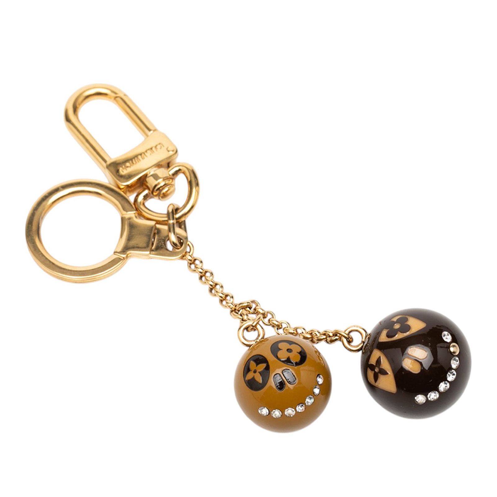Louis Vuitton Jack and Lucie Gold Tone Bag Charm Key Holder: Louis Vuitton Jack and Lucie Gold Tone Bag Charm Key Holder Louis Vuitton Jack and Lucie key holder and bag charm featuring a gold-tone metal body with resin and crystal embellishments. It includes a 