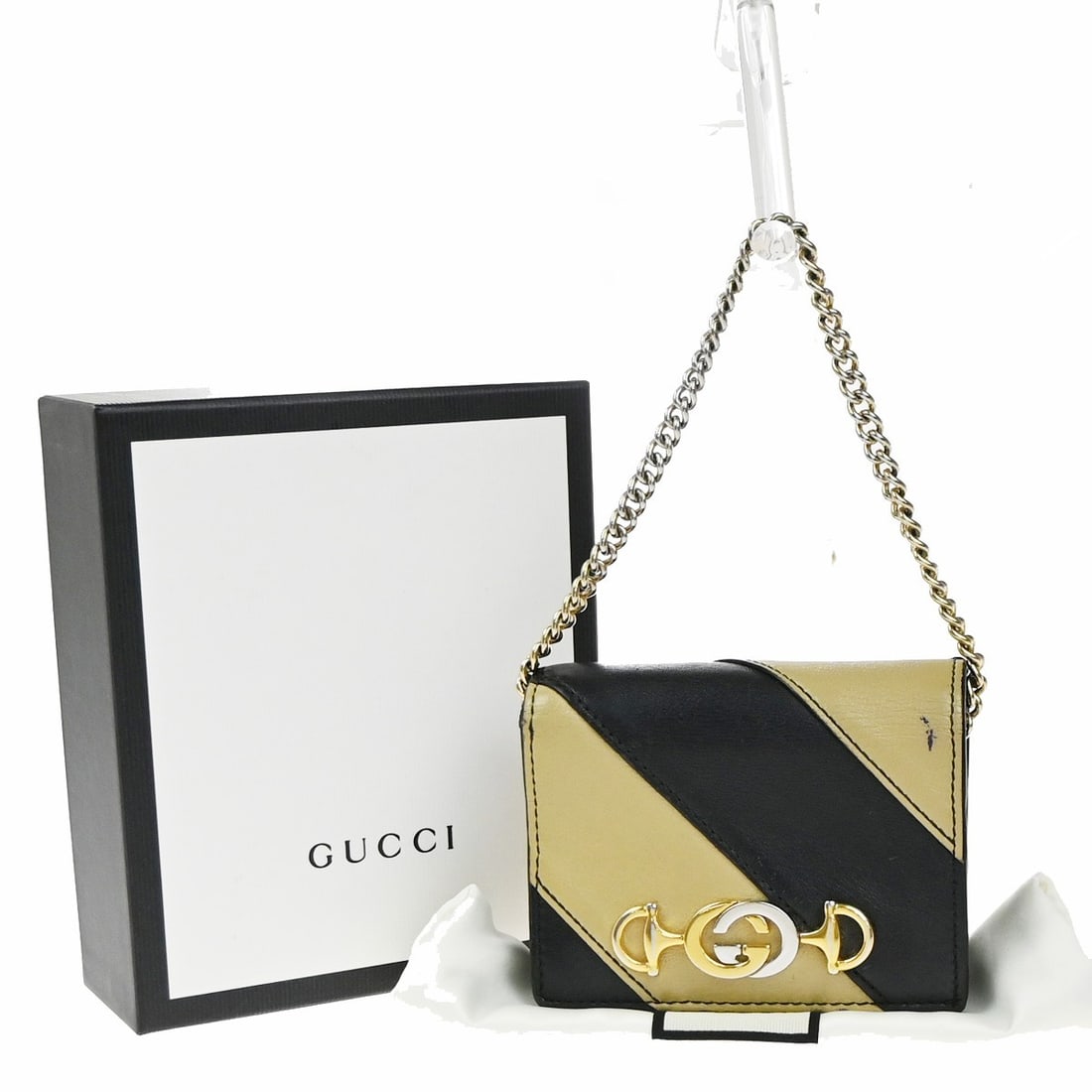 Zumi Quilted Leather Card Holder With Chain By Gucci: Zumi Quilted Leather Card Holder With Chain By Gucci The Gucci Zumi Chain Card Case features a diagonal quilted leather design in black, complemented by gold-plated accents. Designed for women, this c