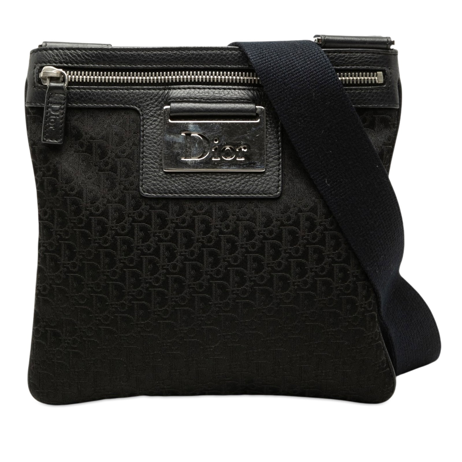 Dior Street Chic Crossbody in Black Diorissimo Trotter Canvas: Dior Street Chic Crossbody in Black Diorissimo Trotter Canvas Diorissimo Trotter Street Chic crossbody bag in black fabric with leather trim. This crossbody features an adjustable flat strap, top zip 