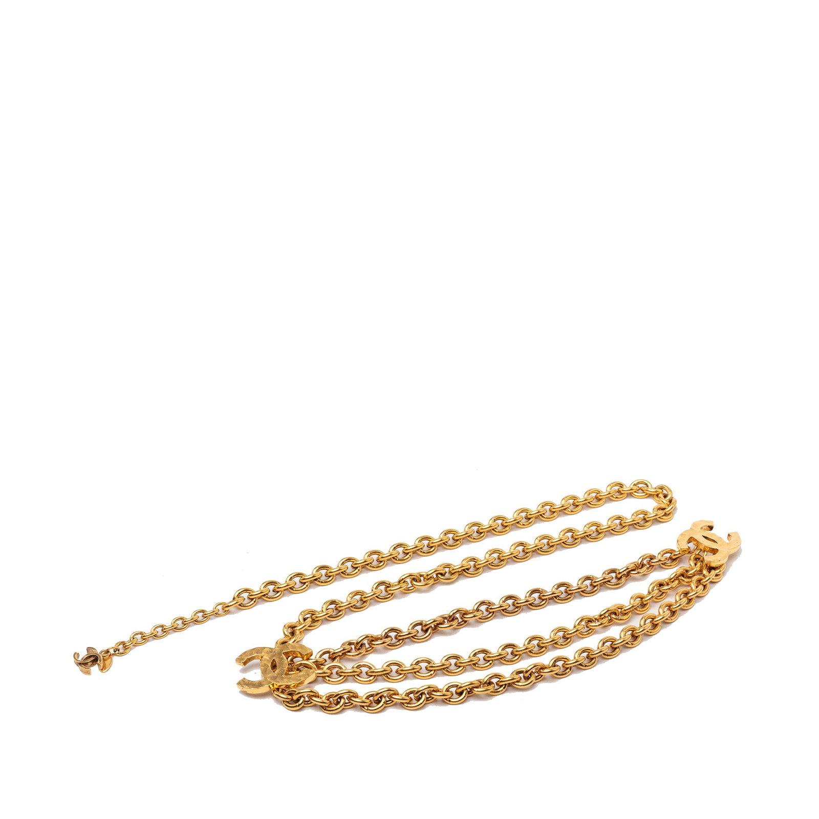Chanel CC Triple Chain Gold Plated Belt: Chanel CC Triple Chain Gold Plated Belt Chanel CC triple chain belt in gold plated metal with a hook closure. Made in France, this accessory features the brand's signature chain styling. Condition is 