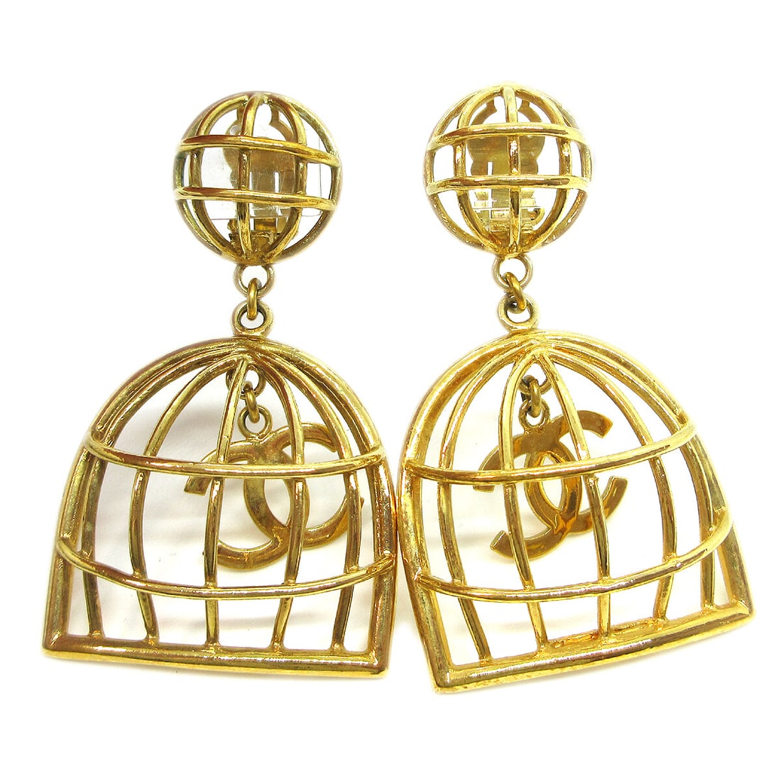 Chanel Birdcage Clip On Dangle Earrings Gold Tone France: Chanel Birdcage Clip On Dangle Earrings Gold Tone France Clip-on dangle earrings by Chanel featuring a birdcage-inspired design with shaking CC logo charms. Finished in gold tone, this pair comes with