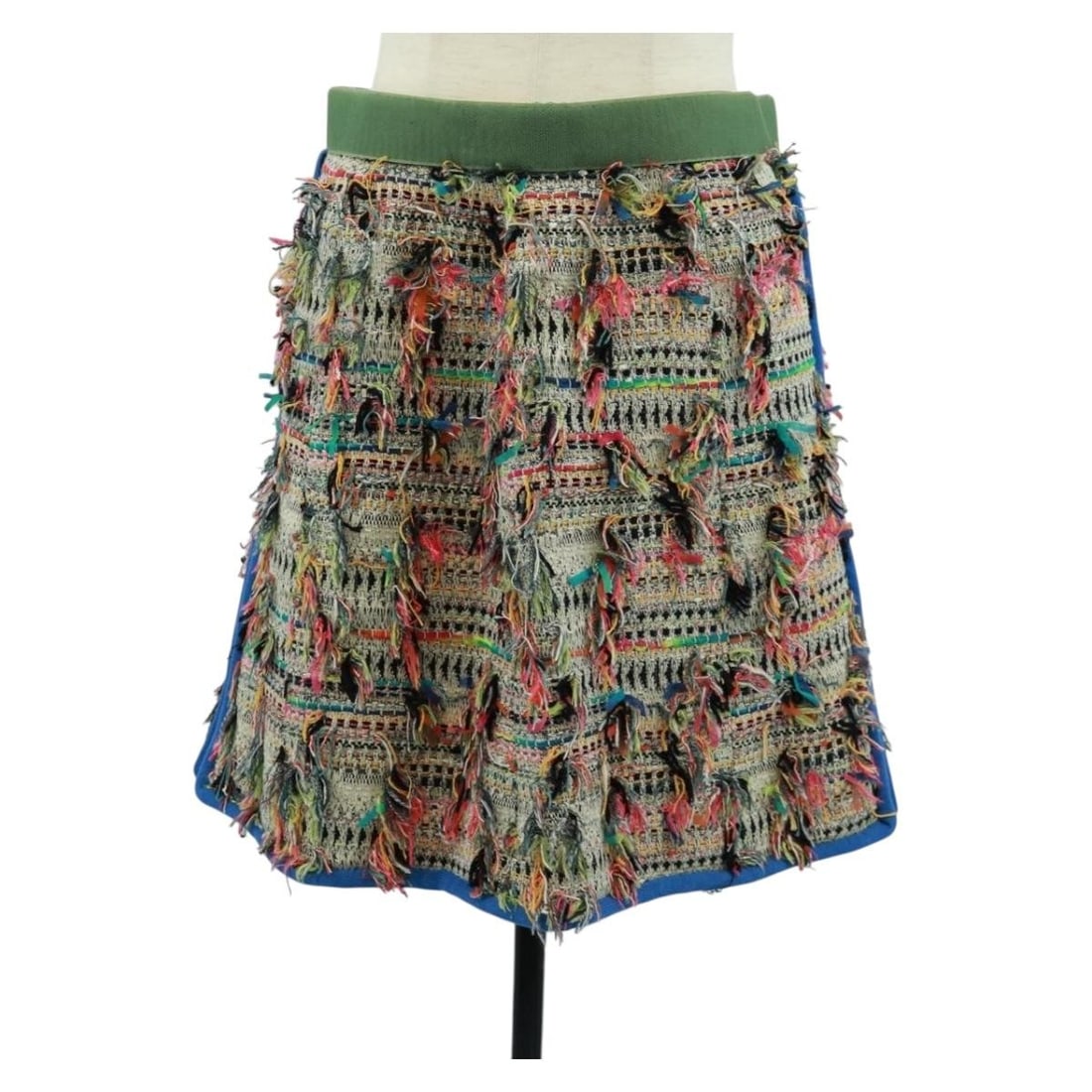 Multicolor Tweed Skirt by CHANEL Canvas Made in France: Multicolor Tweed Skirt by CHANEL Canvas Made in France This CHANEL multicolor tweed skirt features a canvas exterior and is crafted in France. The skirt displays slight rubbing on the surface and inte