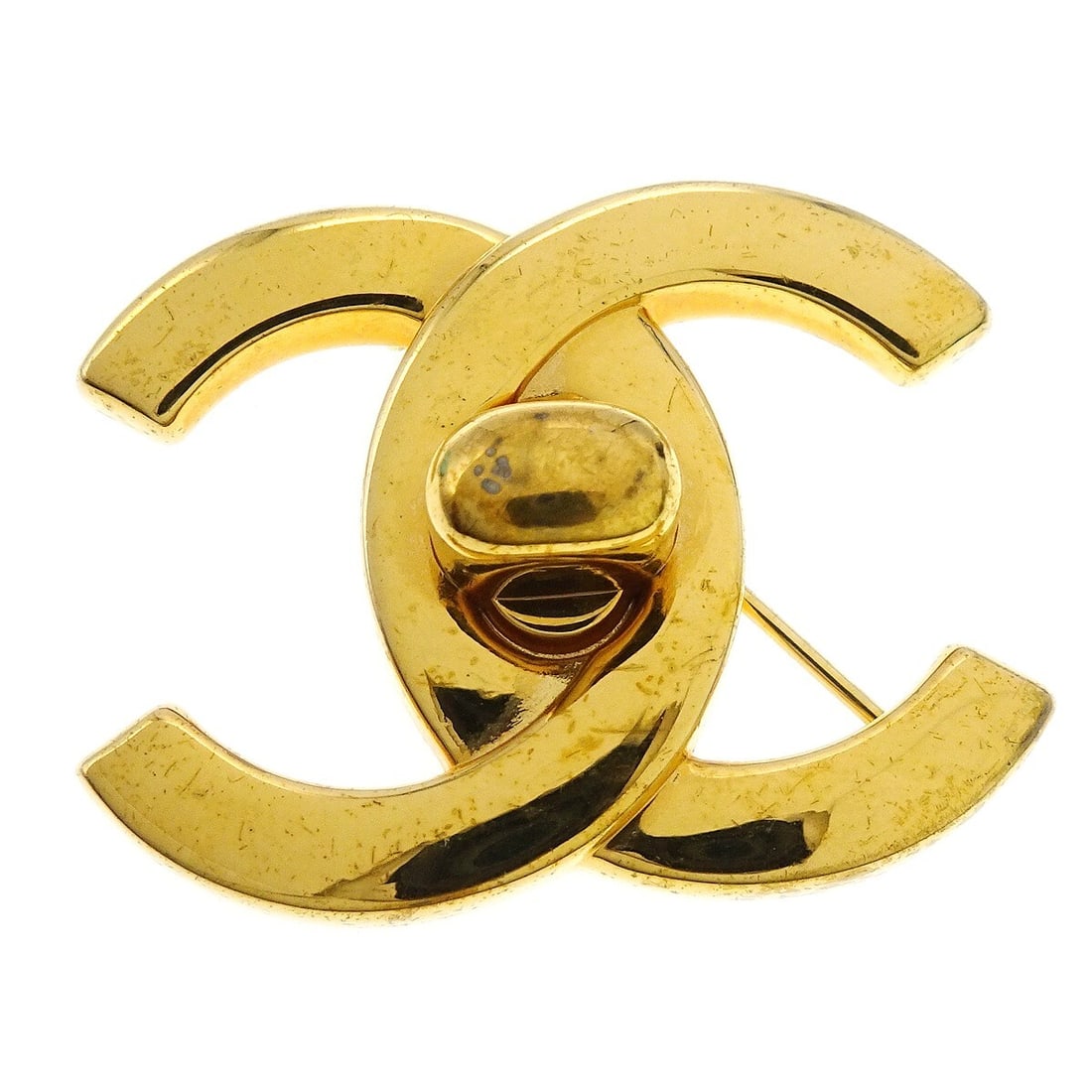 CHANEL Turnlock Gold Plated Vintage Brooch 96A: CHANEL Turnlock Gold Plated Vintage Brooch 96A Vintage Chanel turnlock motif brooch pin in gold-plated metal, made in France. This large brooch features the 96A detail and shows reasonable wear from u