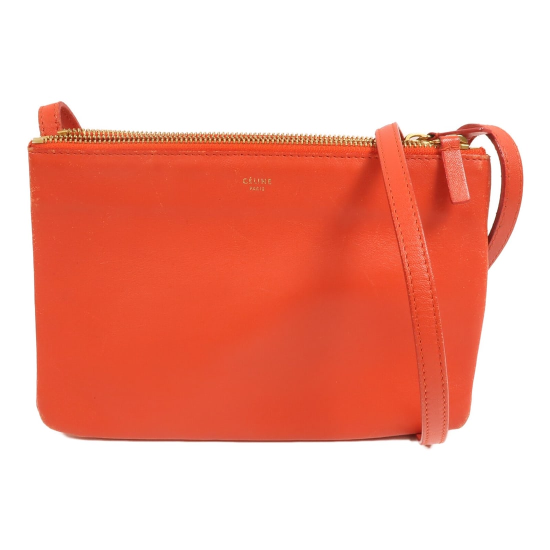 Celine Trio Red Lambskin Shoulder Bag with Gold Tone Hardware: Celine Trio Red Lambskin Shoulder Bag with Gold Tone Hardware This CELINE Trio shoulder bag is crafted from red lambskin (sheep leather) and features a compact silhouette with a shoulder bag style. It