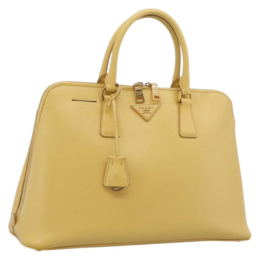 PRADA Saffiano Leather Hand Bag Yellow Gold with Clochette: PRADA Saffiano Leather Hand Bag Yellow Gold with Clochette Prada women's hand bag in yellow/gold Saffiano leather with a structured silhouette and clochette accessory. Made in Italy, this pre-owned ba