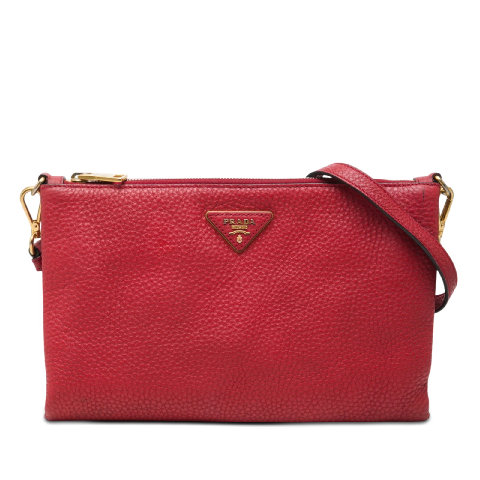 Prada Vitello Daino red leather crossbody bag: Prada Vitello Daino red leather crossbody bag Prada Vitello Daino crossbody bag in red leather with a detachable flat leather strap, top zip closure, and interior zip and slip pockets. Made in Italy. 