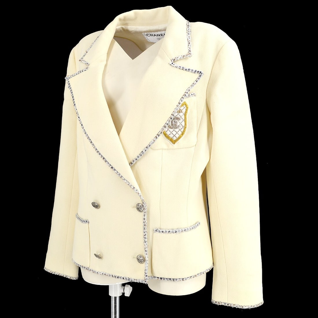 CHANEL 05C Wool Jacket Size 42 Ivory Double Breasted: CHANEL 05C Wool Jacket Size 42 Ivory Double Breasted Chanel 05C double-breasted long sleeve jacket in ivory with a mid-length silhouette, collared neckline, and logo button accents. Made in France fro