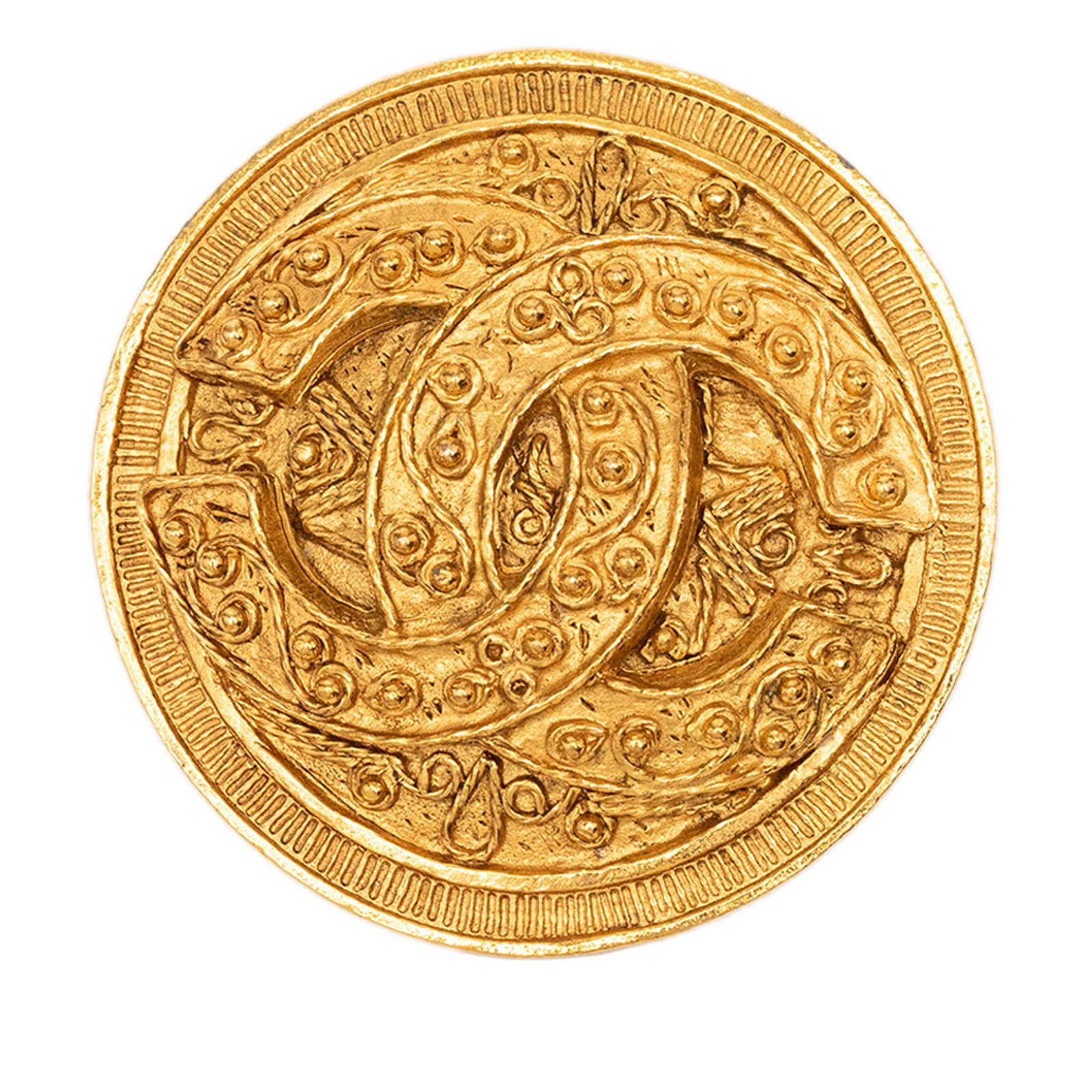 Chanel CC Filigree Gold Tone Round Brooch: Chanel CC Filigree Gold Tone Round Brooch This Chanel brooch showcases a round filigree design crafted from gold-tone metal and features the signature CC motif. It is equipped with a back pin closure 