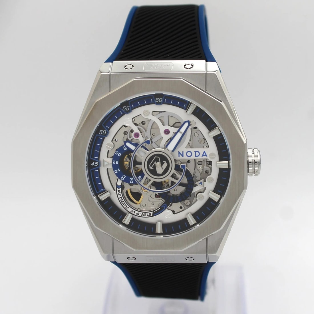 43mm Blue Skeleton Dial Noda Aero Series-1 Stainless Steel Automatic Wristwatch: 43mm Blue Skeleton Dial Noda Aero Series-1 Stainless Steel Automatic Wristwatch The Noda Aero Series-1 is an un-used luxury wristwatch featuring a 43mm brushed stainless steel octagonal case and a str