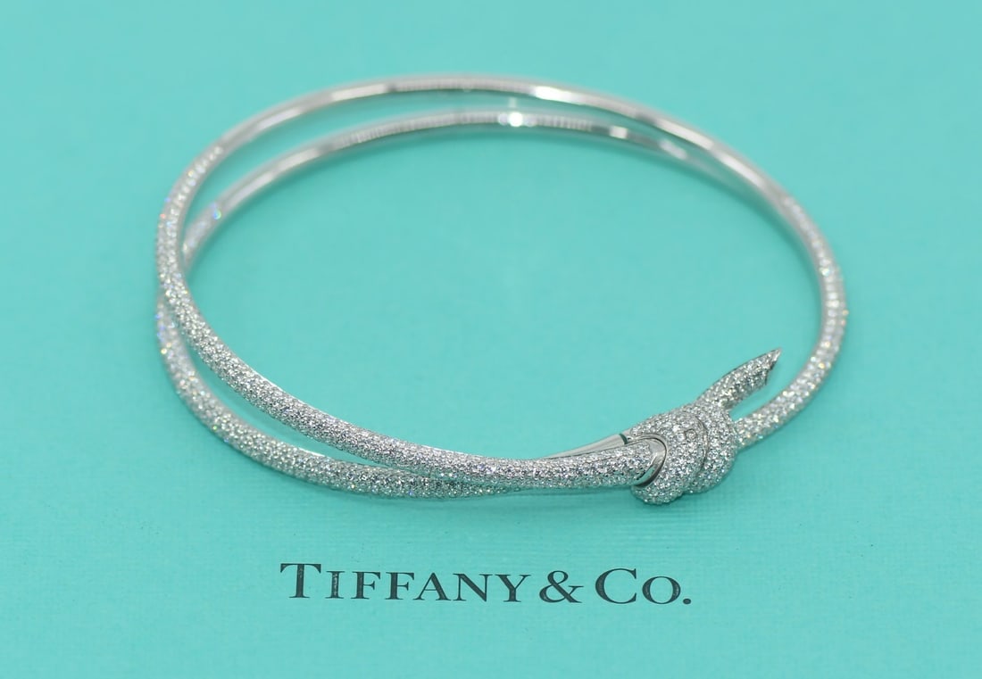 Tiffany & Co Double Knot 4.55 CT Diamond Bangle 18K White Gold Bracelet: Tiffany & Co Double Knot 4.55 CT Diamond Bangle 18K White Gold Bracelet This exquisite Tiffany & Co. Double Knot Bracelet is a stunning piece that showcases a bold design crafted from 18K white gold. 