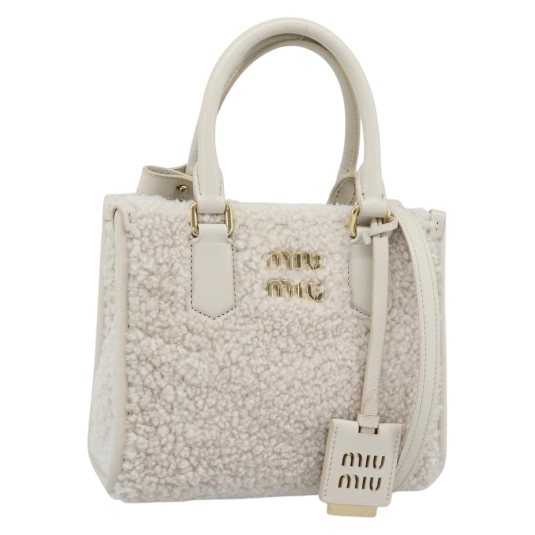 Miu Miu 2way Canvas Handbag White Gold with Strap Dust Bag: Miu Miu 2way Canvas Handbag White Gold with Strap Dust Bag Miu Miu hand bag in white and gold canvas, made in Italy. This 2-way style comes with a shoulder strap and dust bag. The bag measures approxi