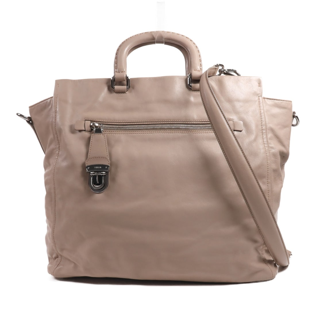 PRADA beige calfskin 2 way shoulder handbag with strap: PRADA beige calfskin 2 way shoulder handbag with strap Prada 2-way shoulder bag in beige calfskin leather with silver-tone hardware. Designed for women, this handbag includes a shoulder strap and feat