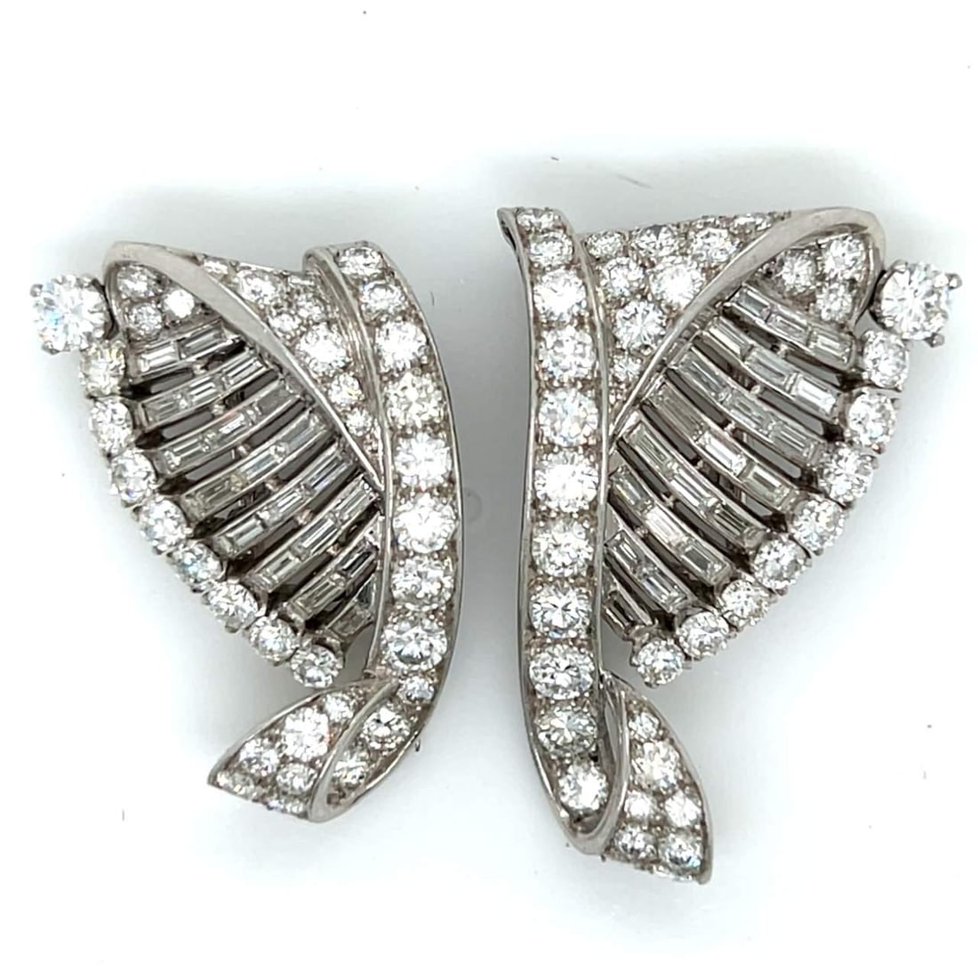 Art Deco Platinum Diamond Clips 7.00 Ct with 41 Baguette Diamonds: Art Deco Platinum Diamond Clips 7.00 Ct with 41 Baguette Diamonds Experience the elegance of the Art Deco era with these stunning platinum diamond clips. Crafted with precision, these clips weigh 23.6