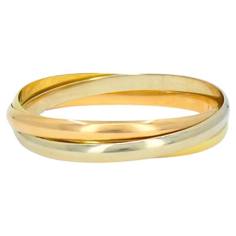 Cartier Trinity 18k Tri Color Gold Bracelet Vintage France: Cartier Trinity 18k Tri Color Gold Bracelet Vintage France Vintage Cartier Trinity bracelet made of 18k yellow, white, and rose gold. The design features three interlocking smooth, slightly rounded ba