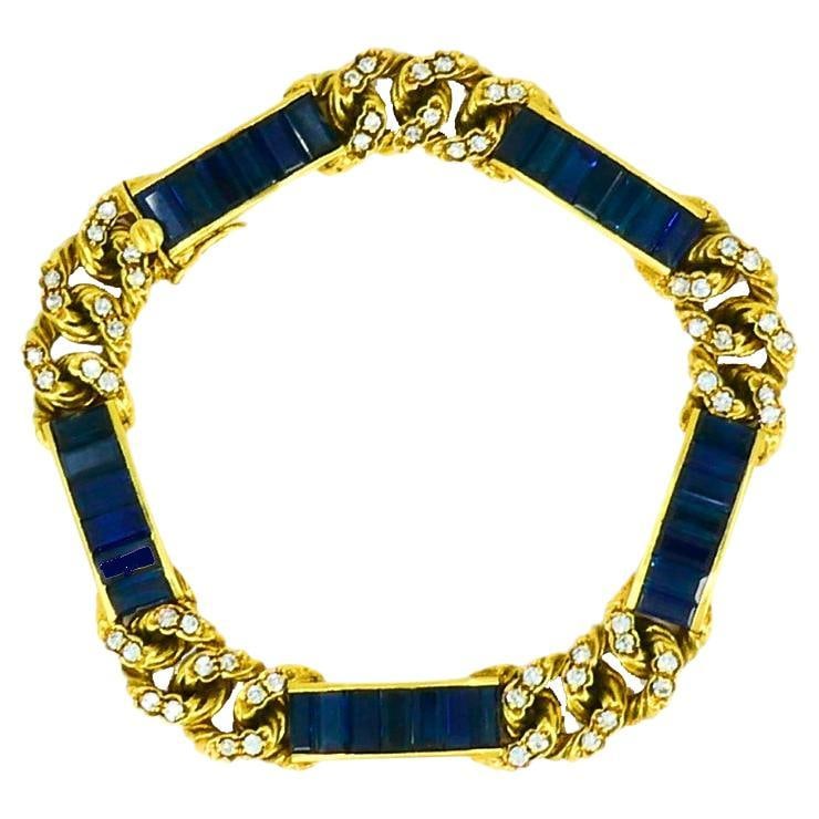 Fred Paris 18k Yellow Gold Link Bracelet with Sapphires and Diamonds: Fred Paris 18k Yellow Gold Link Bracelet with Sapphires and Diamonds Vintage Fred Paris bracelet crafted in 18k yellow gold with sapphires and diamonds. The design features baguette-cut blue sapphires