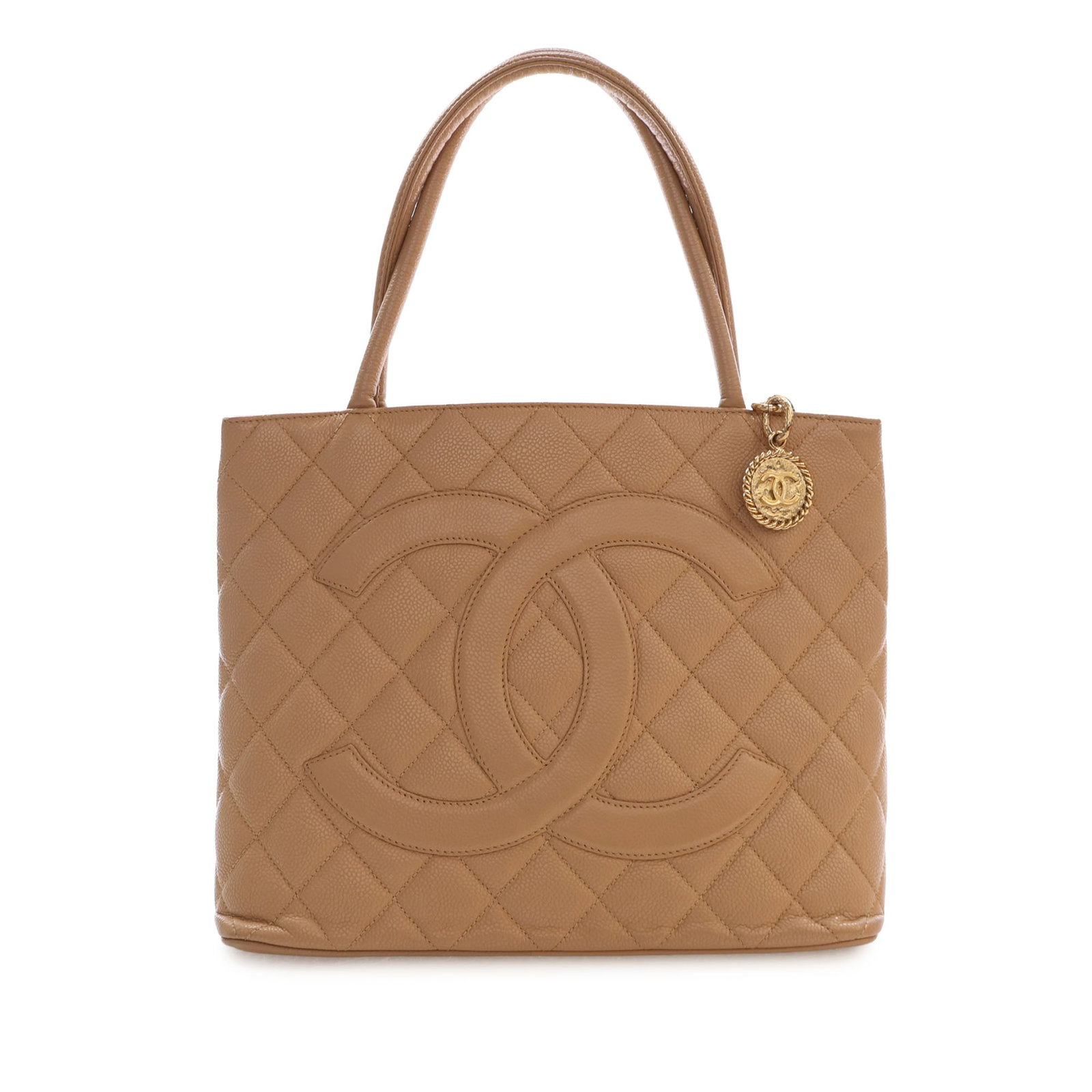 Chanel Medallion Tote in Beige Caviar Leather: Chanel Medallion Tote in Beige Caviar Leather Chanel Medallion tote crafted in quilted caviar leather with rolled leather handles and a top zip closure. The bag includes an exterior back slip pocket a