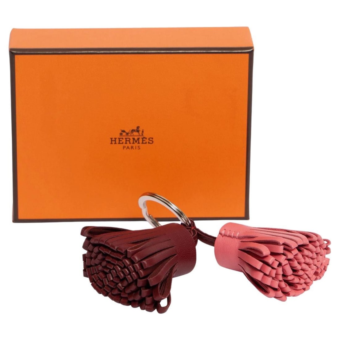 Hermes Double Carmen Leather Bag Charm in Red and Pink: Hermes Double Carmen Leather Bag Charm in Red and Pink This exquisite Hermes Double Carmen Bag Charm is a stunning accessory that adds a touch of luxury to any bag. Crafted from fine red and pink leat