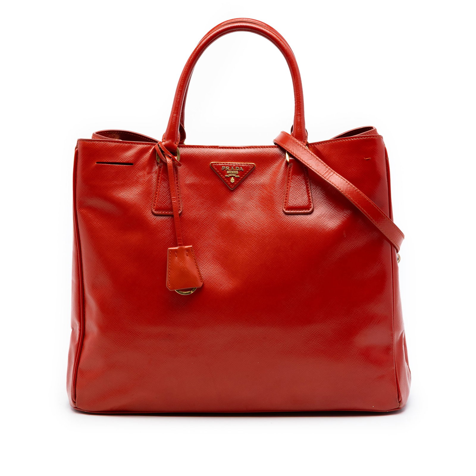 Prada orange leather Galleria satchel with strap: Prada orange leather Galleria satchel with strap This Prada Large Saffiano Vernice Galleria Satchel is crafted in orange patent saffiano leather and features rolled handles and a detachable flat leath