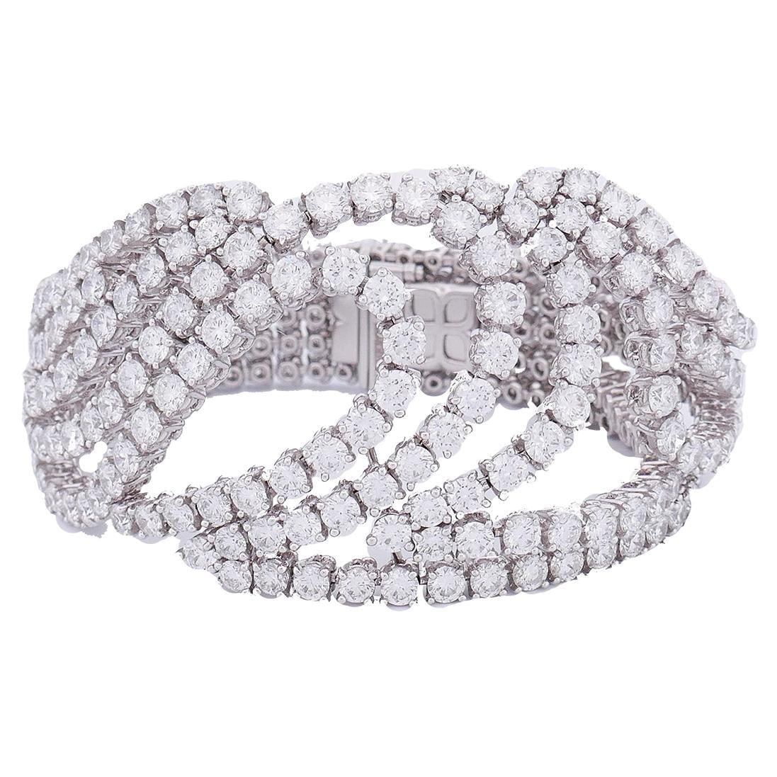 Boucheron Diamond Bracelet in 18k White Gold France: Boucheron Diamond Bracelet in 18k White Gold France An estate Boucheron bracelet crafted in 18k white gold and set with diamonds. The design features ten flexible gold and diamond strings that meet in