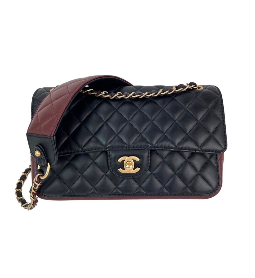 Chanel Calfskin Quilted Strap Flap Shoulder Bag Black Burgundy: Chanel Calfskin Quilted Strap Flap Shoulder Bag Black Burgundy This stunning Chanel Calfskin Quilted Strap into Flap Shoulder Bag features a sleek rectangular shape and a sophisticated black exterior 