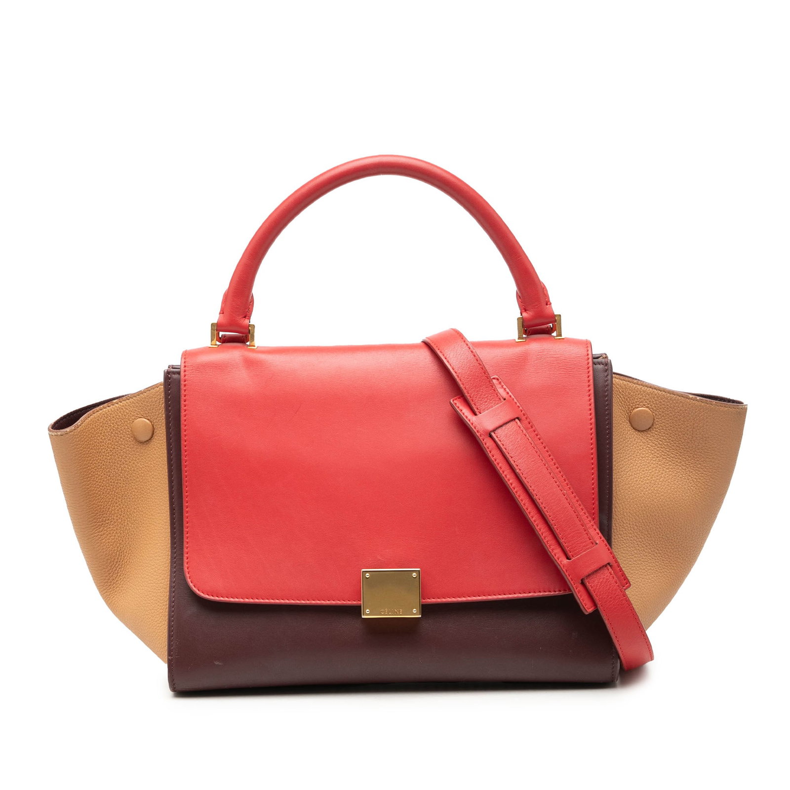 Celine Trapeze Small Leather Satchel Bag in Red: Celine Trapeze Small Leather Satchel Bag in Red Celine Small Tricolor Trapeze satchel crafted in leather with a structured silhouette. It features a rolled top handle, a detachable flat strap, a front