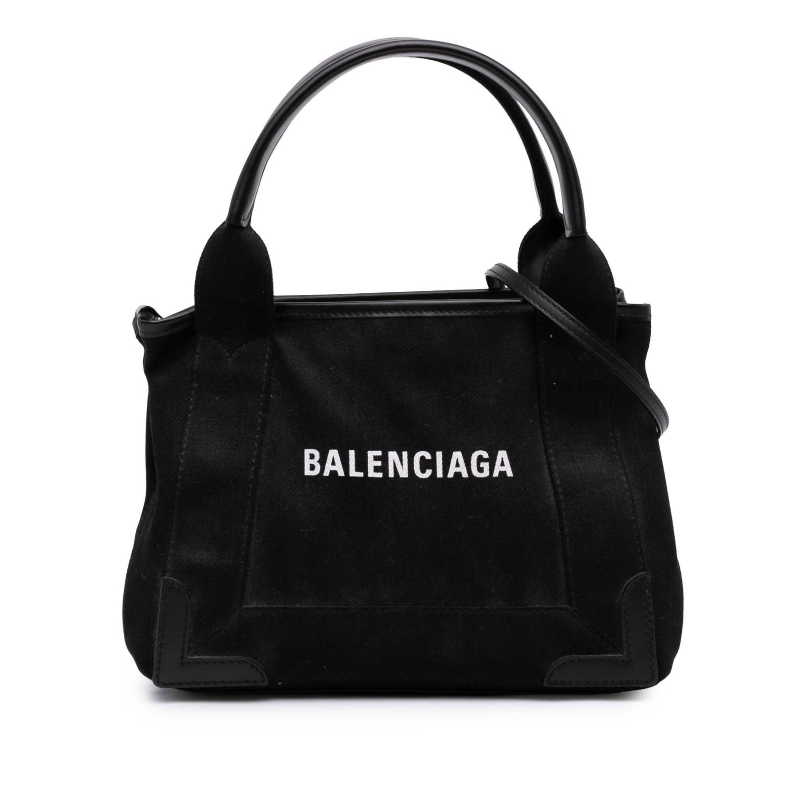 Balenciaga Navy Cabas XS denim satchel with leather trim: Balenciaga Navy Cabas XS denim satchel with leather trim Balenciaga Navy Cabas Satchel XS crafted with a denim body and leather trim. This satchel features flat leather handles, a detachable flat leat