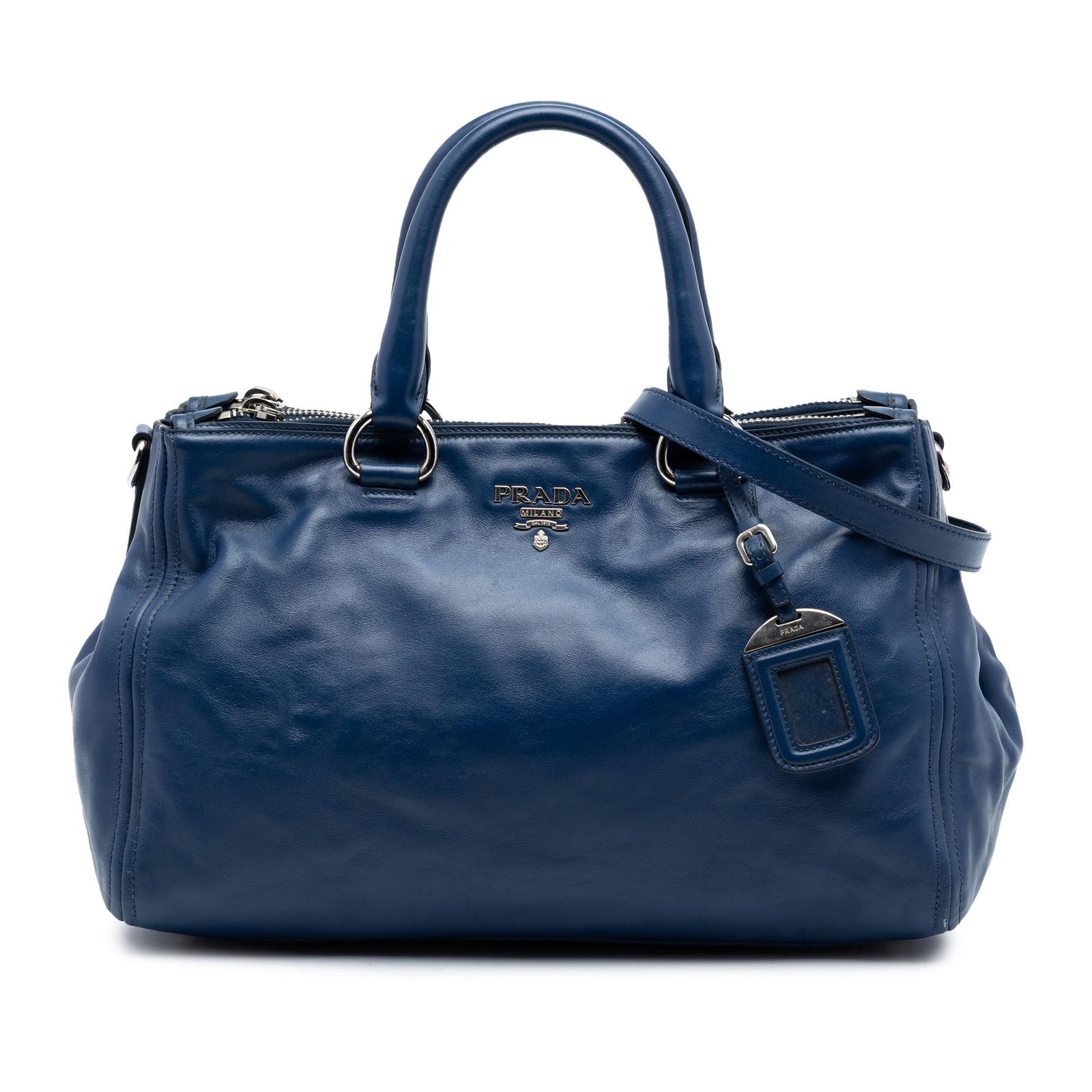 Prada Soft Calf Double Zip Leather Satchel Blue: Prada Soft Calf Double Zip Leather Satchel Blue Prada Soft Calf Double Zip Convertible Tote in blue leather with rolled handles, a detachable flat strap, and an open top with snap closure. The interio