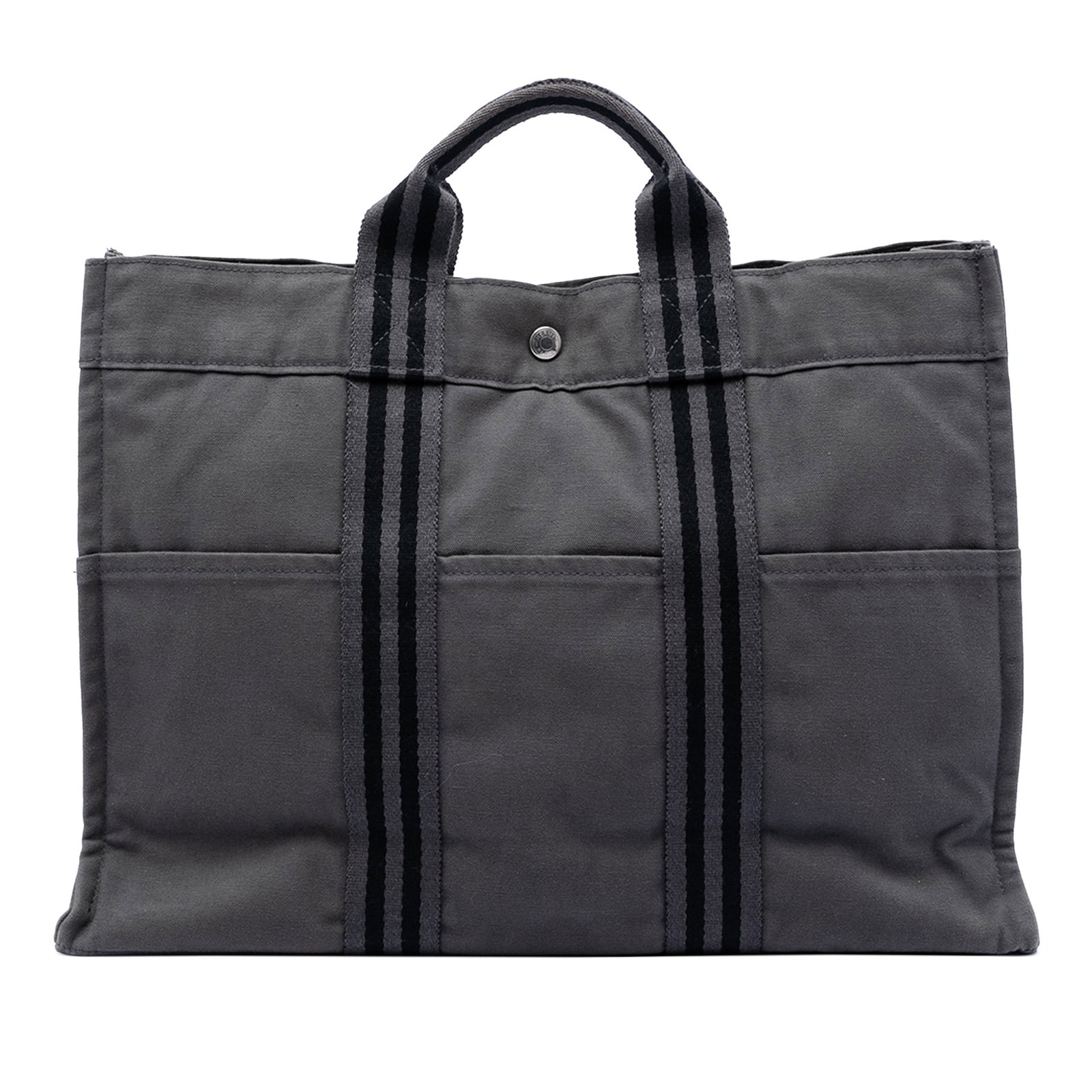 Hermes Fourre Tout MM Gray Canvas Tote Bag: Hermes Fourre Tout MM Gray Canvas Tote Bag This Hermes Fourre Tout MM tote features a durable canvas body in gray, complemented by exterior front and back slip pockets and flat handles. The open top i