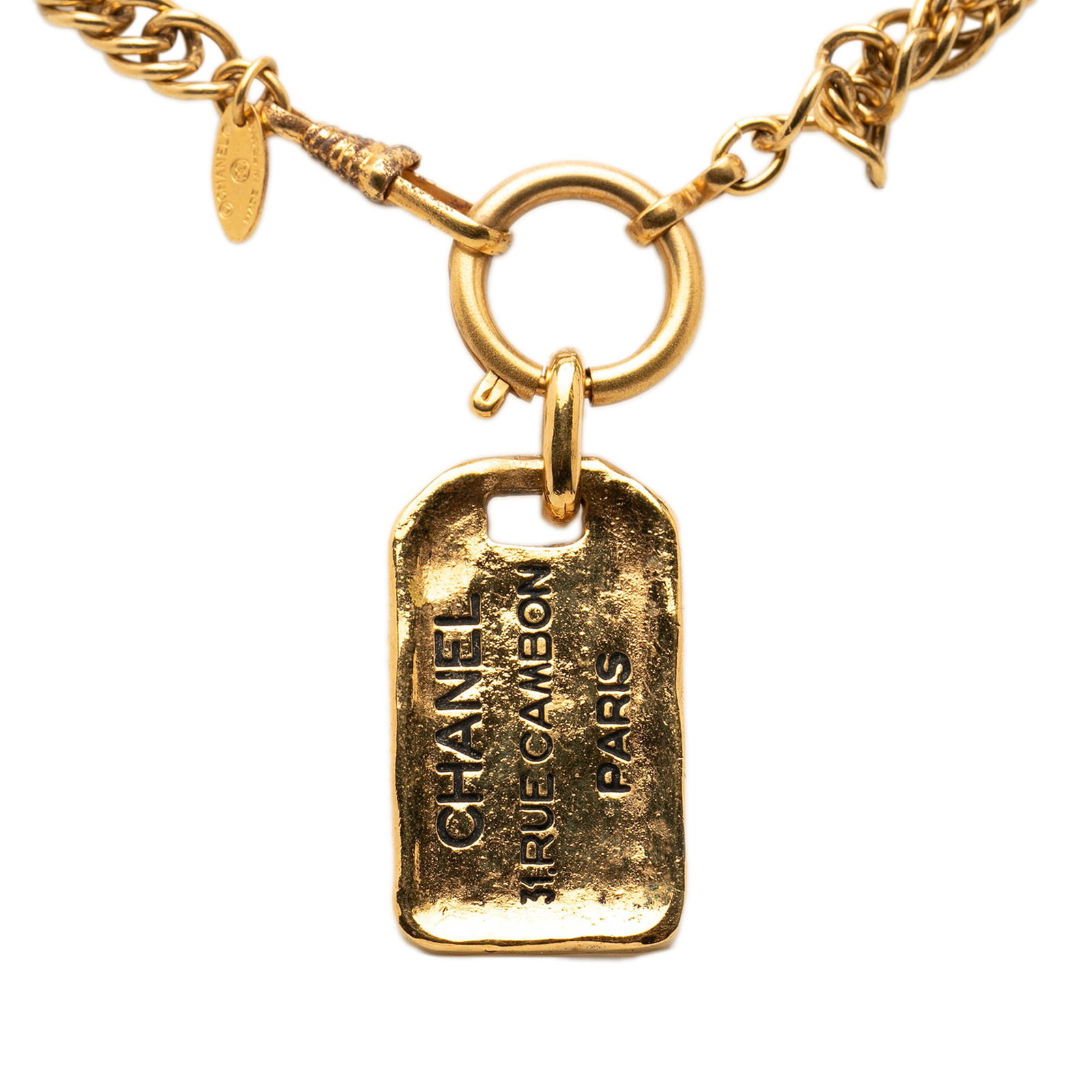 Chanel gold tone plaque pendant necklace 31 Rue Cambon: Chanel gold tone plaque pendant necklace 31 Rue Cambon This Chanel necklace features a gold-tone metal plaque pendant inscribed with "31 Rue Cambon" on a matching gold-tone chain. It is secured with a