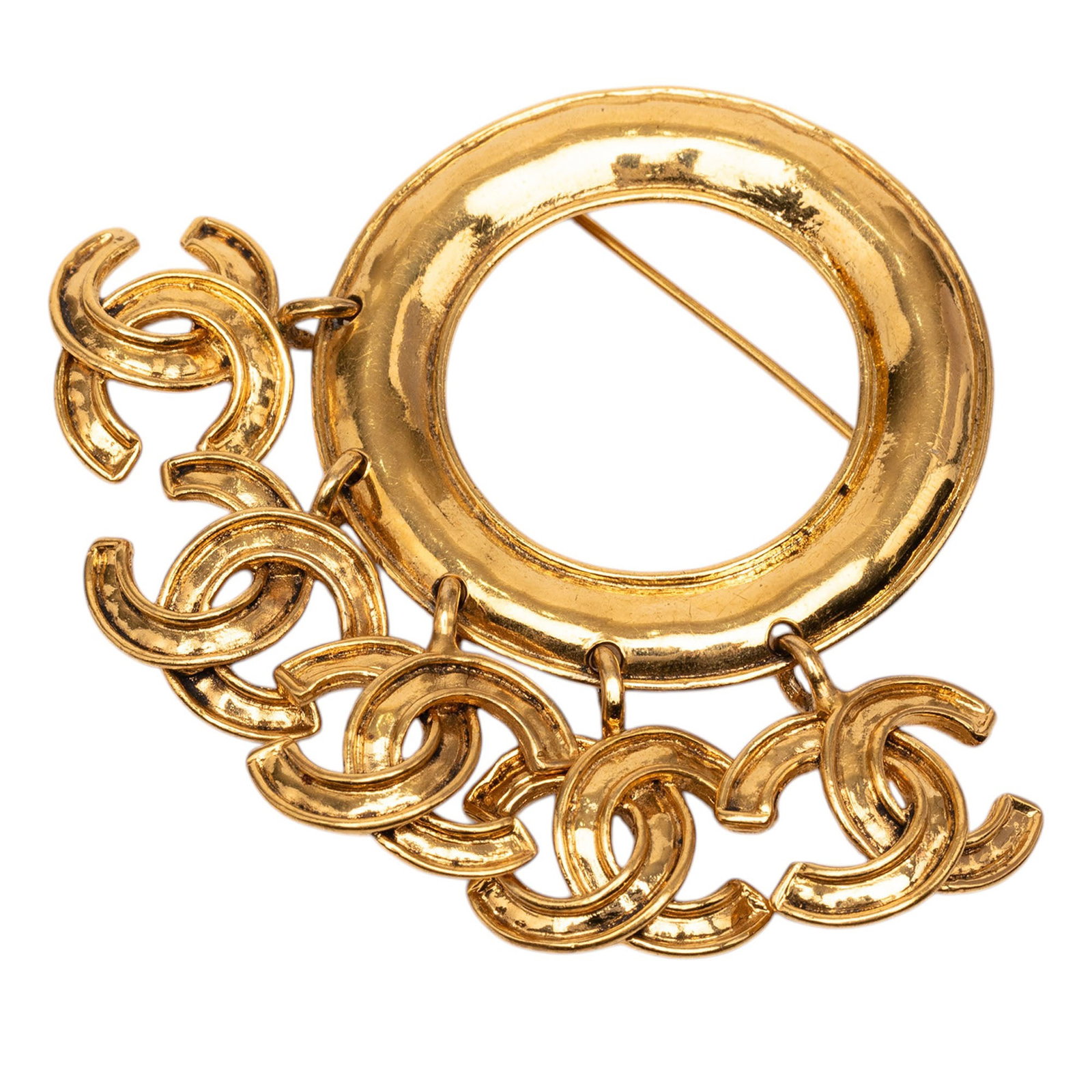 Chanel CC gold-tone metal brooch with five charm ring: Chanel CC gold-tone metal brooch with five charm ring This Chanel brooch showcases a gold-tone metal construction adorned with five distinctive charms and features a back pin closure. Designed as a st