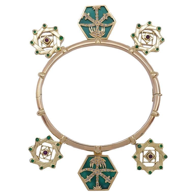 Cartier 18k Yellow Gold Charm Bracelet with Gemstone Charms France: Cartier 18k Yellow Gold Charm Bracelet with Gemstone Charms France Vintage Cartier charm bracelet in 18k yellow gold, featuring six charms with diamond, emerald, malachite, and ruby accents. The desig