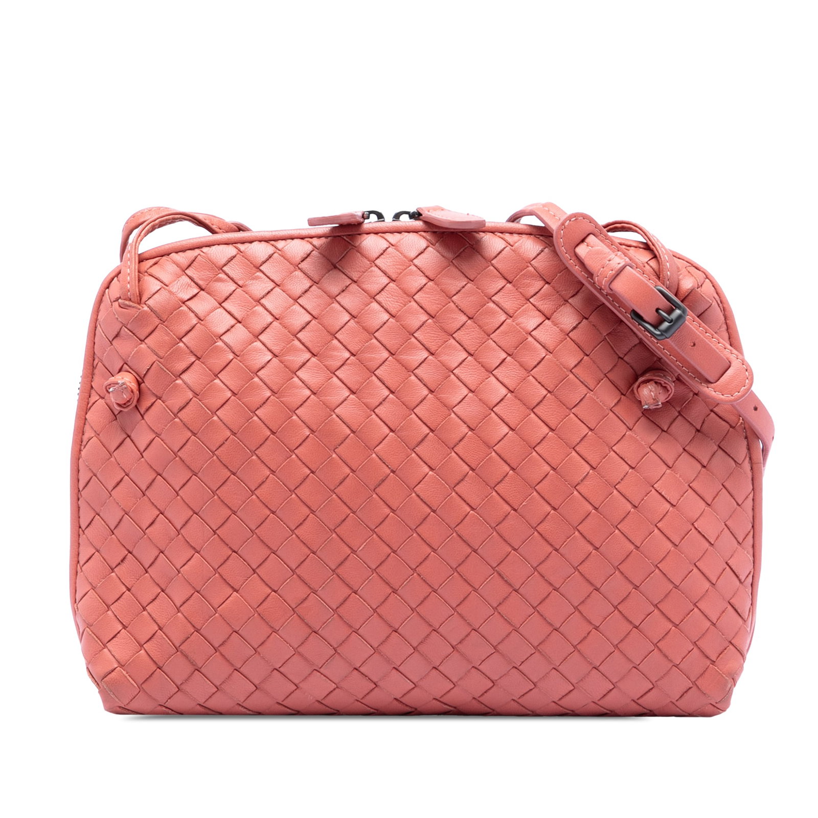 Pink Intrecciato Nodini Leather Crossbody Bag by Bottega Veneta: Pink Intrecciato Nodini Leather Crossbody Bag by Bottega Veneta This Bottega Veneta Nodini crossbody bag features a woven leather exterior in pink, a flat leather strap, a top zip closure, and interio