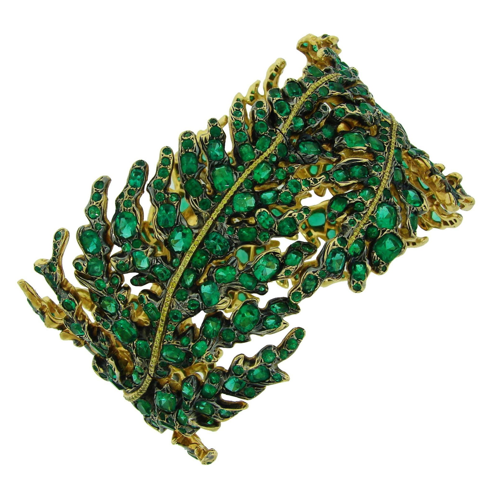 Michele Della Valle 18k Gold Bracelet with Emeralds and Yellow Diamonds: Michele Della Valle 18k Gold Bracelet with Emeralds and Yellow Diamonds A Michele della Valle bracelet in 18k white and yellow gold, featuring a floral design set with emeralds and yellow diamonds. Th