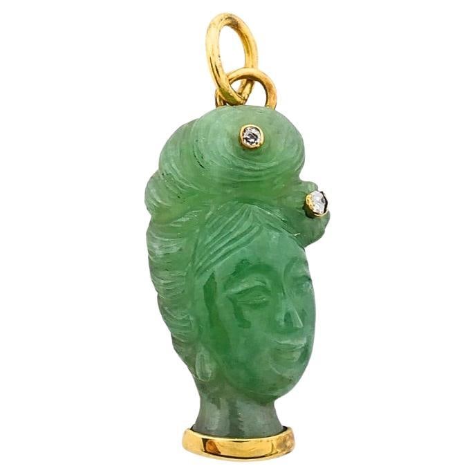 14k Gold Jade Lady Head Pendant with Diamond Accents: 14k Gold Jade Lady Head Pendant with Diamond Accents Vintage charm pendant in 14k gold featuring a finely carved green jade lady's head accented with two small round diamonds. The stylized female prof