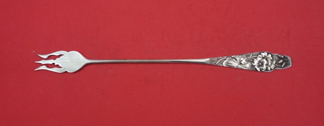 Sterling Silver Flora Pattern 3-Tine Pickle Fork with Geranium 8.25 Inch: Sterling Silver Flora Pattern 3-Tine Pickle Fork with Geranium 8.25 Inch This is a sterling silver pickle fork in the Flora pattern by Shiebler. Featuring a 3-tine design with a geranium motif, this s
